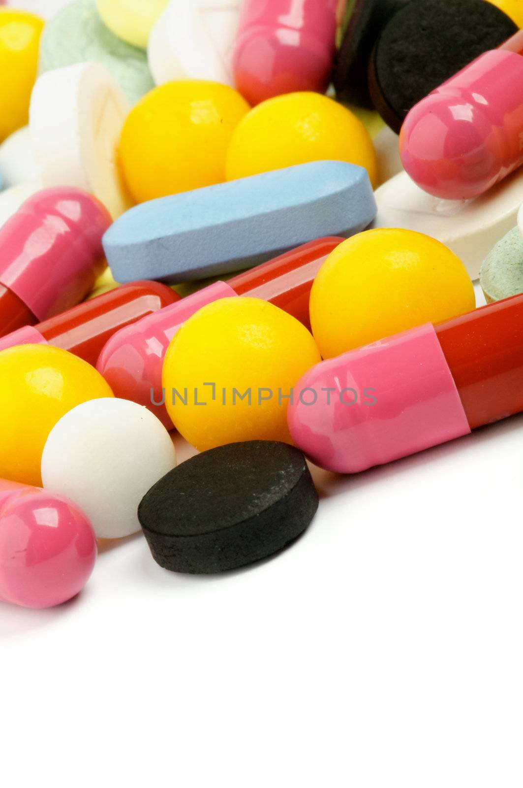 Heap of Multi Colored Pills closeup on white background