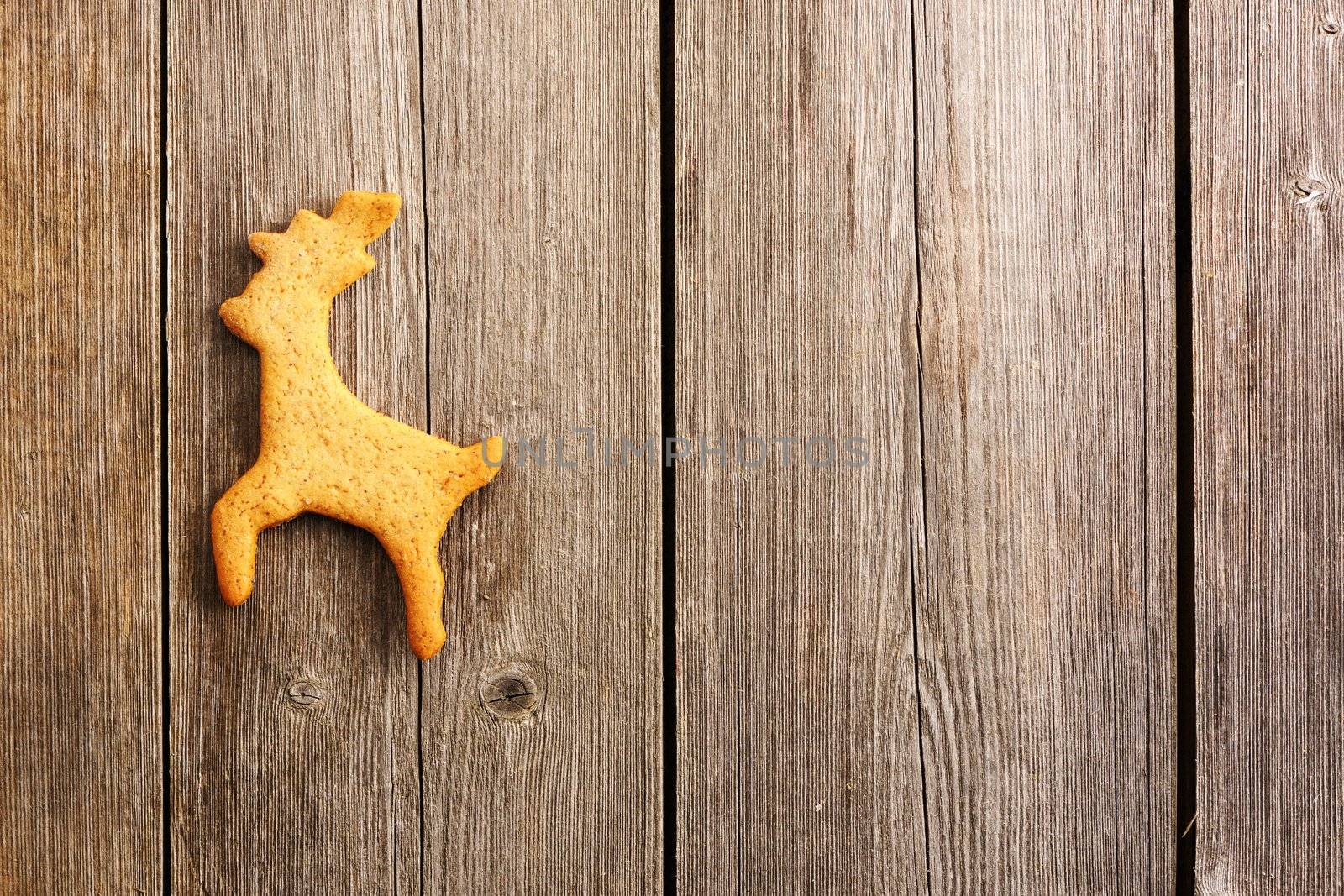 Christmas homemade gingerbread deer over wooden table