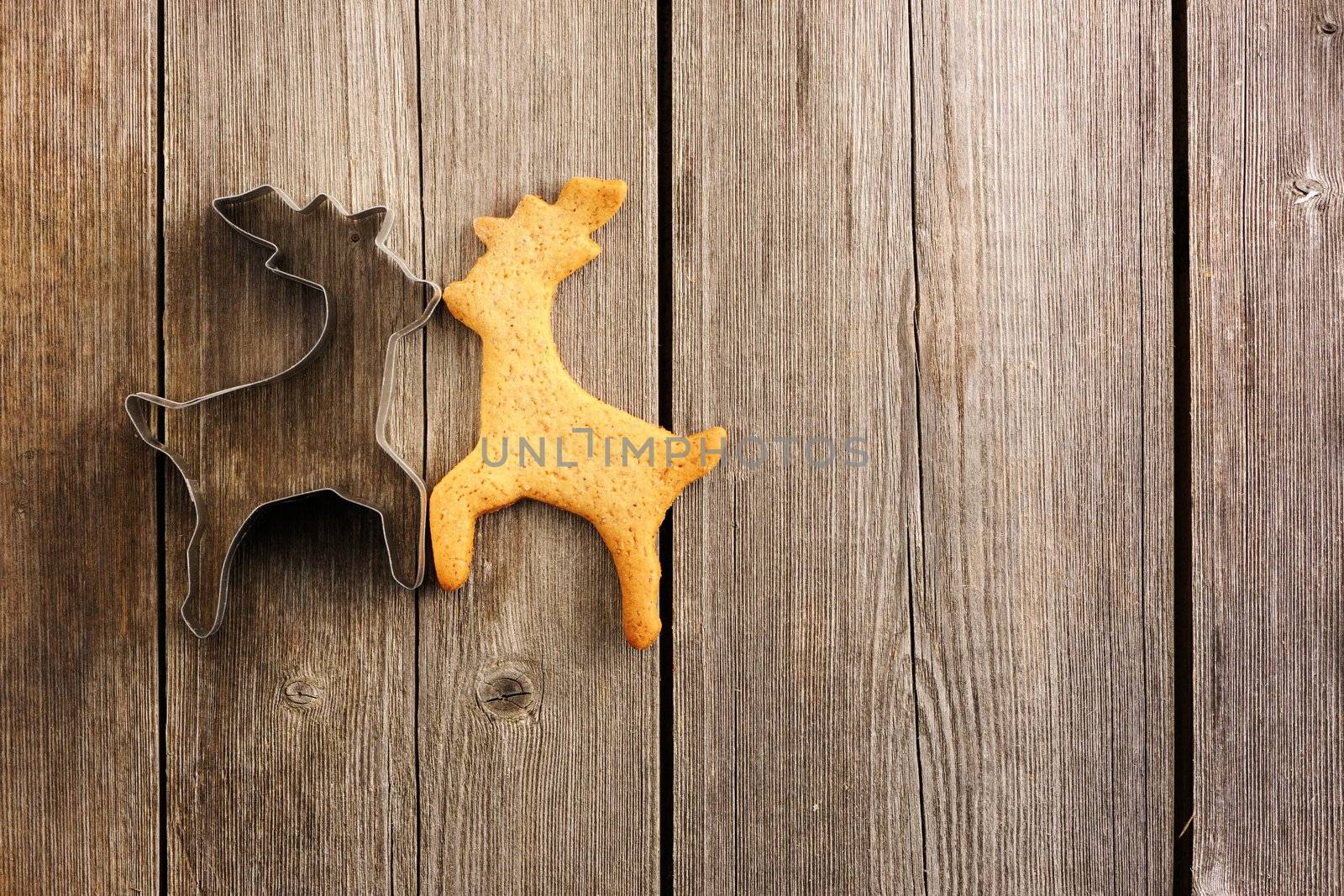 Christmas homemade gingerbread deer over wooden table