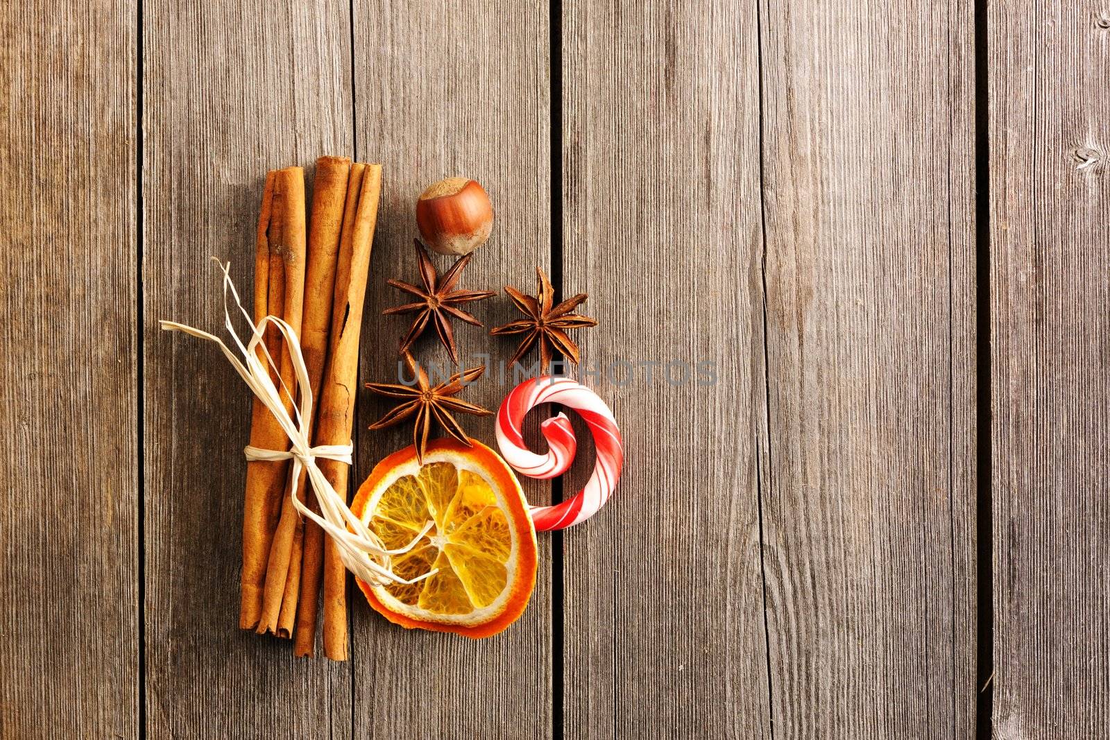 Cinnamon sticks and other spices over wooden table