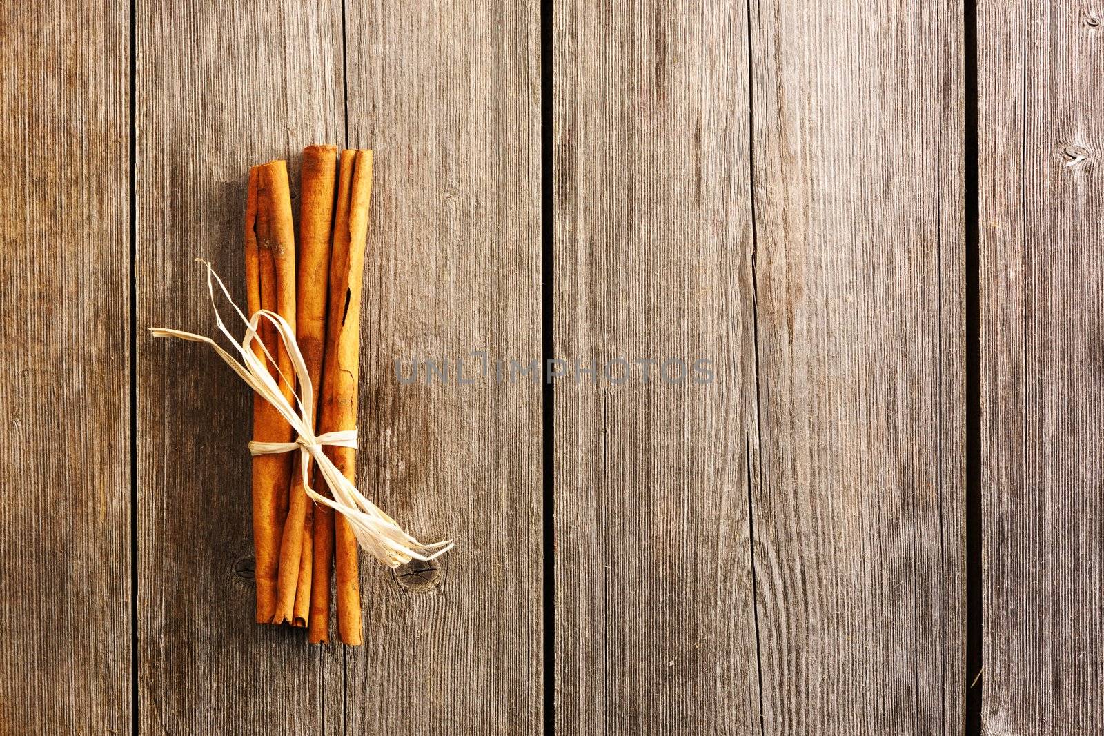 Cinnamon sticks over wooden table