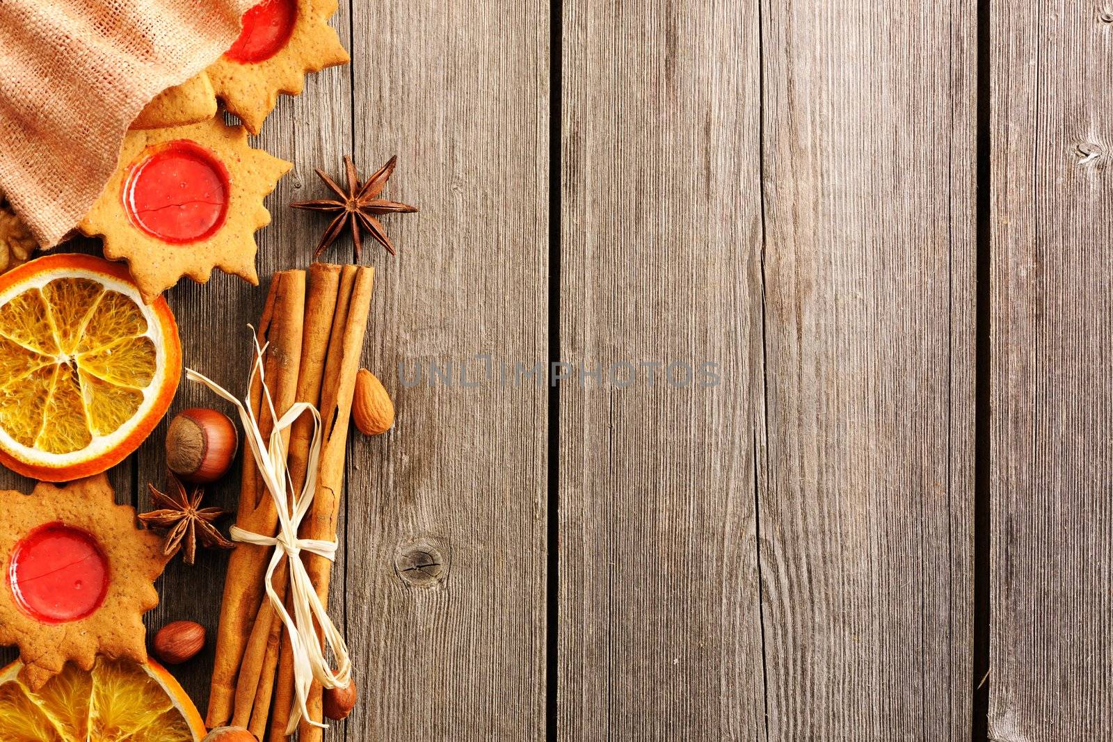 Christmas homemade gingerbread cookie and spices over wooden table