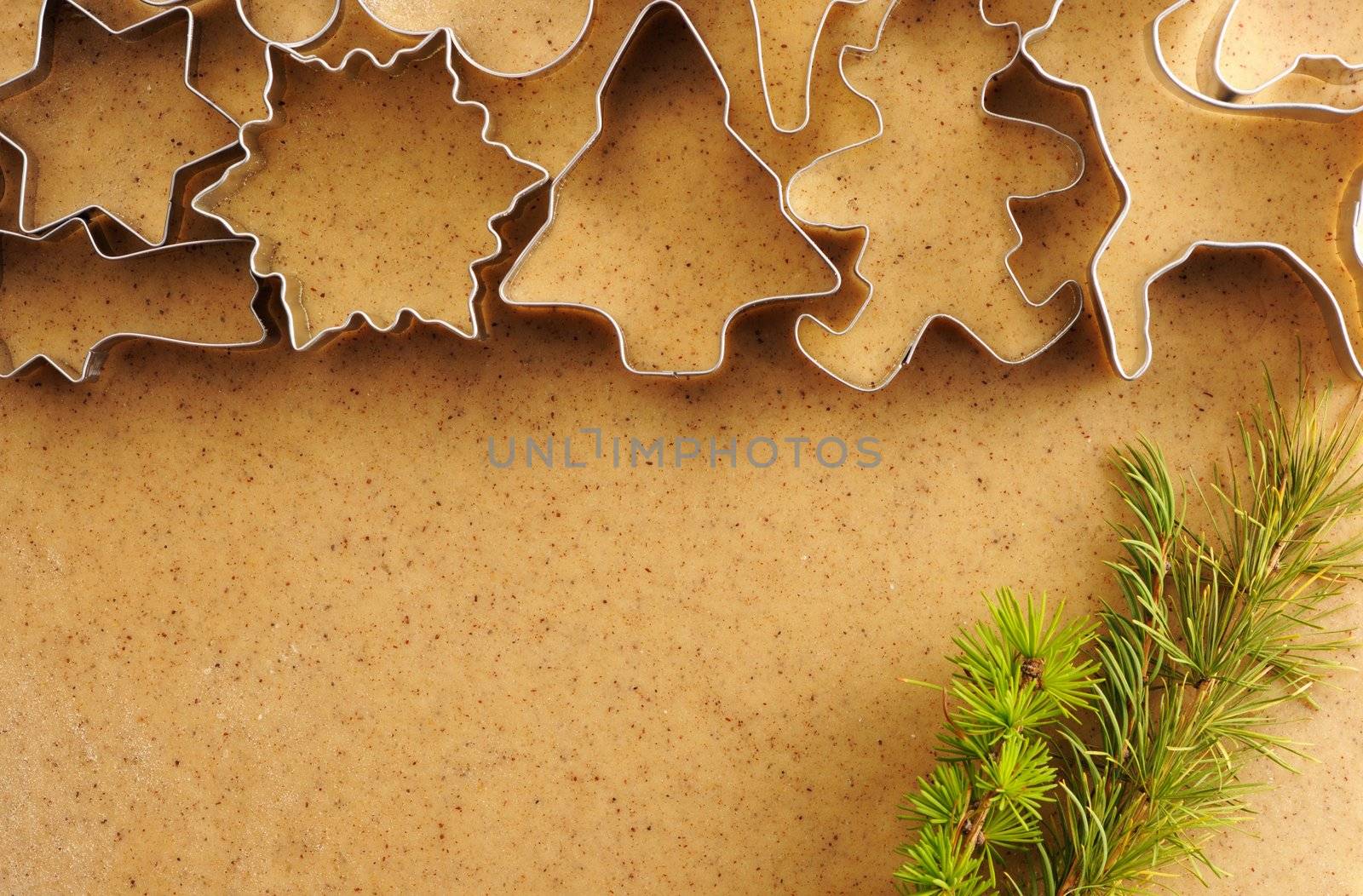 Christmas cookie cutters over homemade gingerbread dough