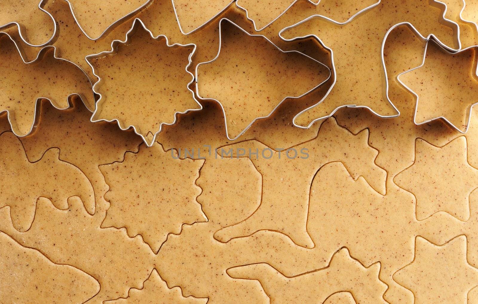 Christmas cookie cutters over homemade gingerbread dough