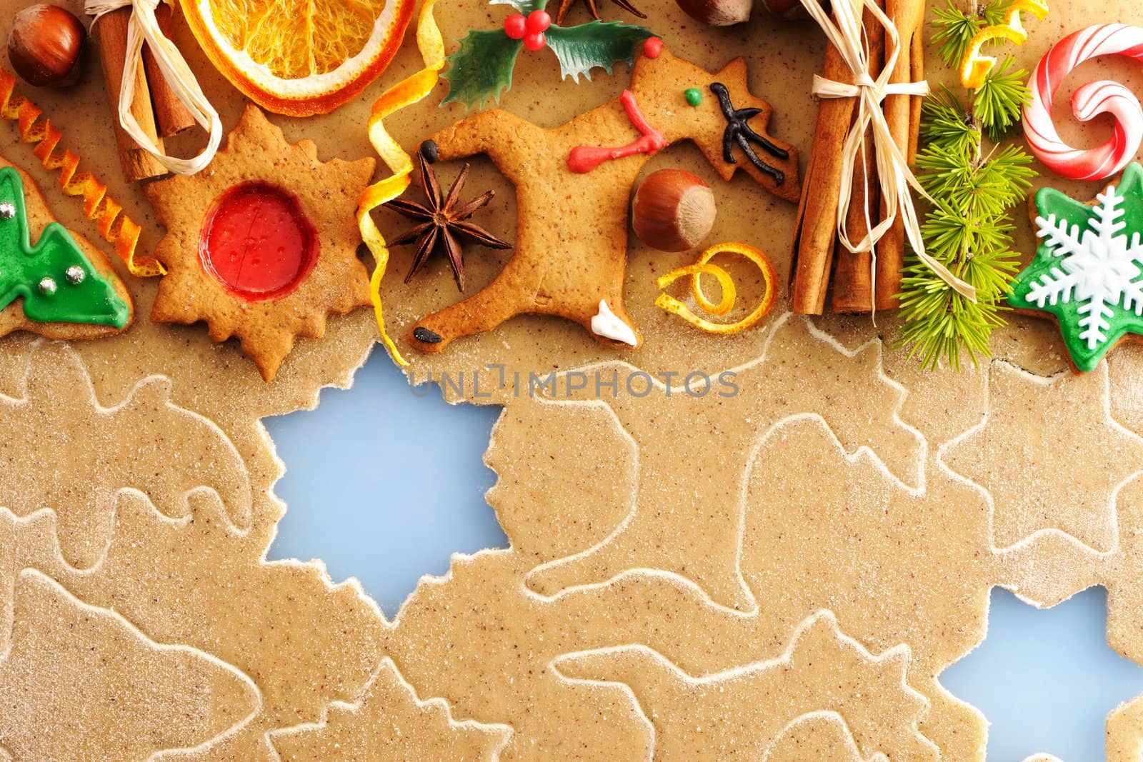 Christmas spices and cookies over homemade gingerbread dough