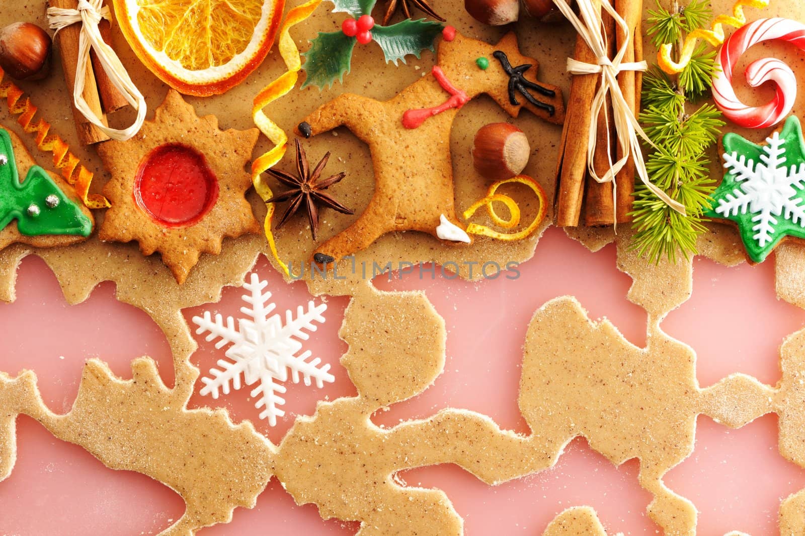Christmas spices and cookies over homemade gingerbread dough