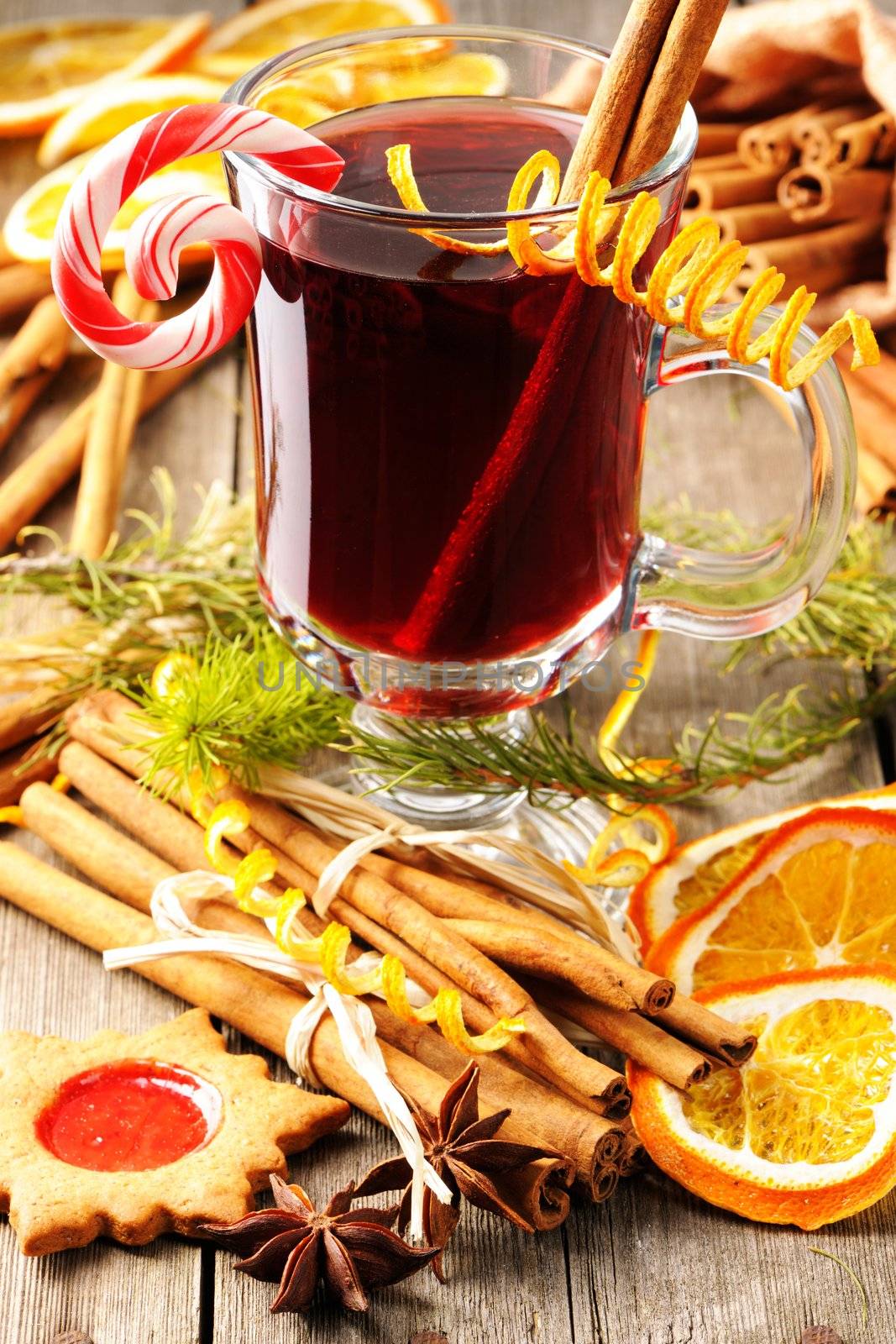 Glass of red mulled wine on wooden table
