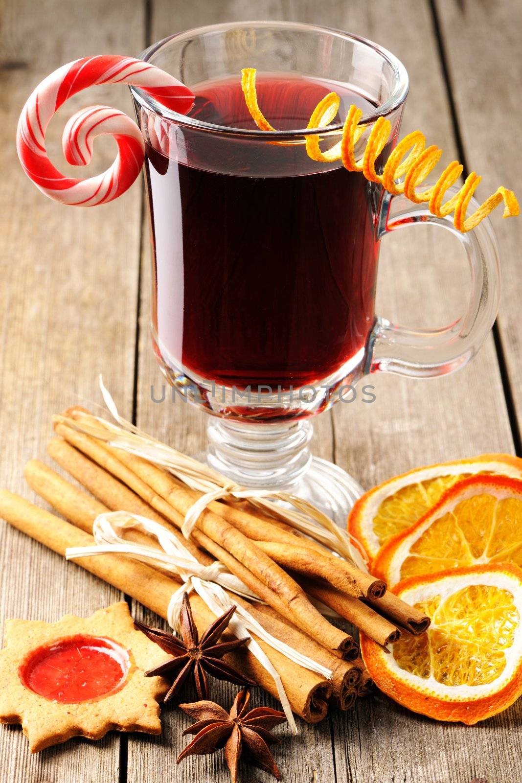 Glass of red mulled wine on wooden table