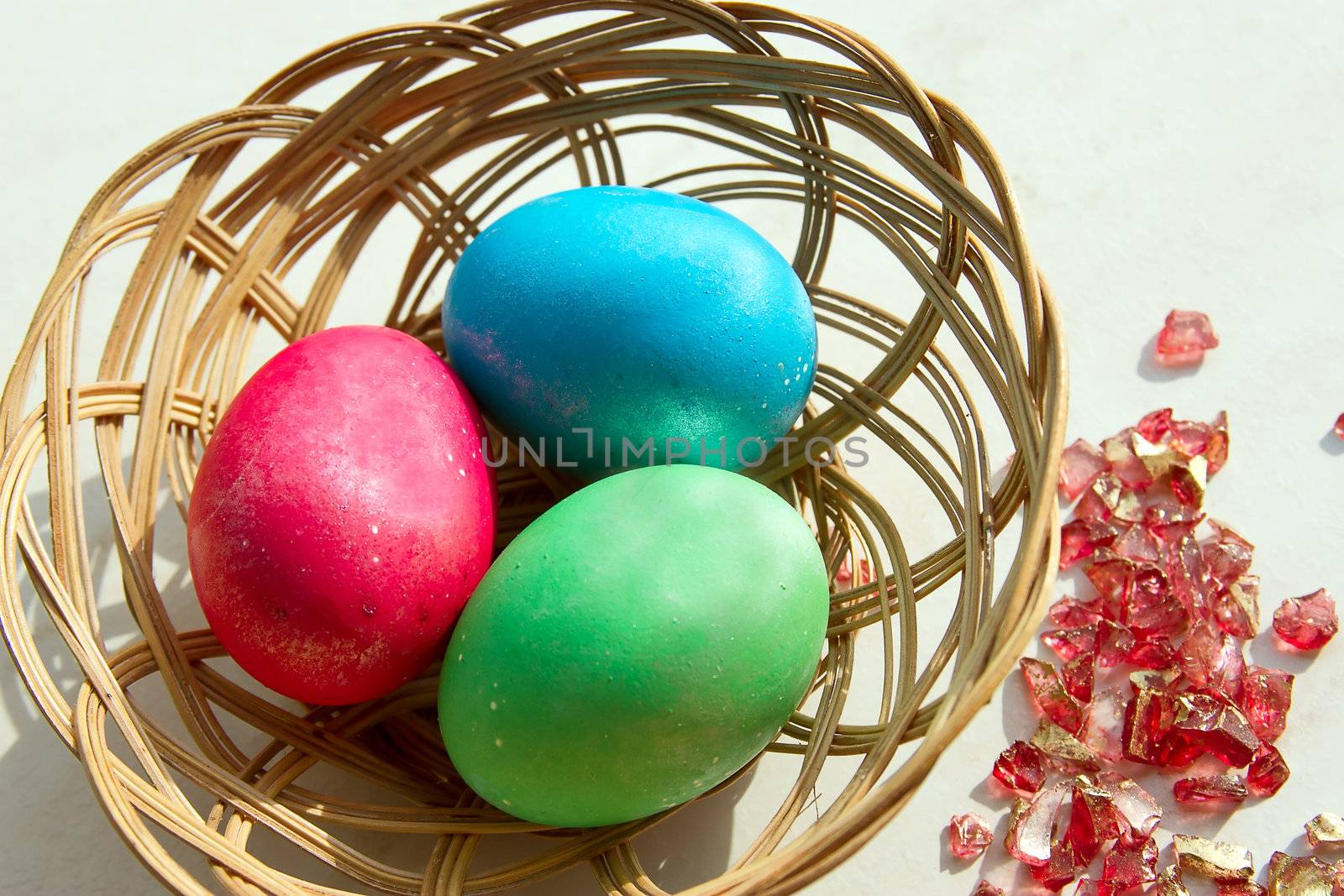 easter basket with easter eggs on wooden background