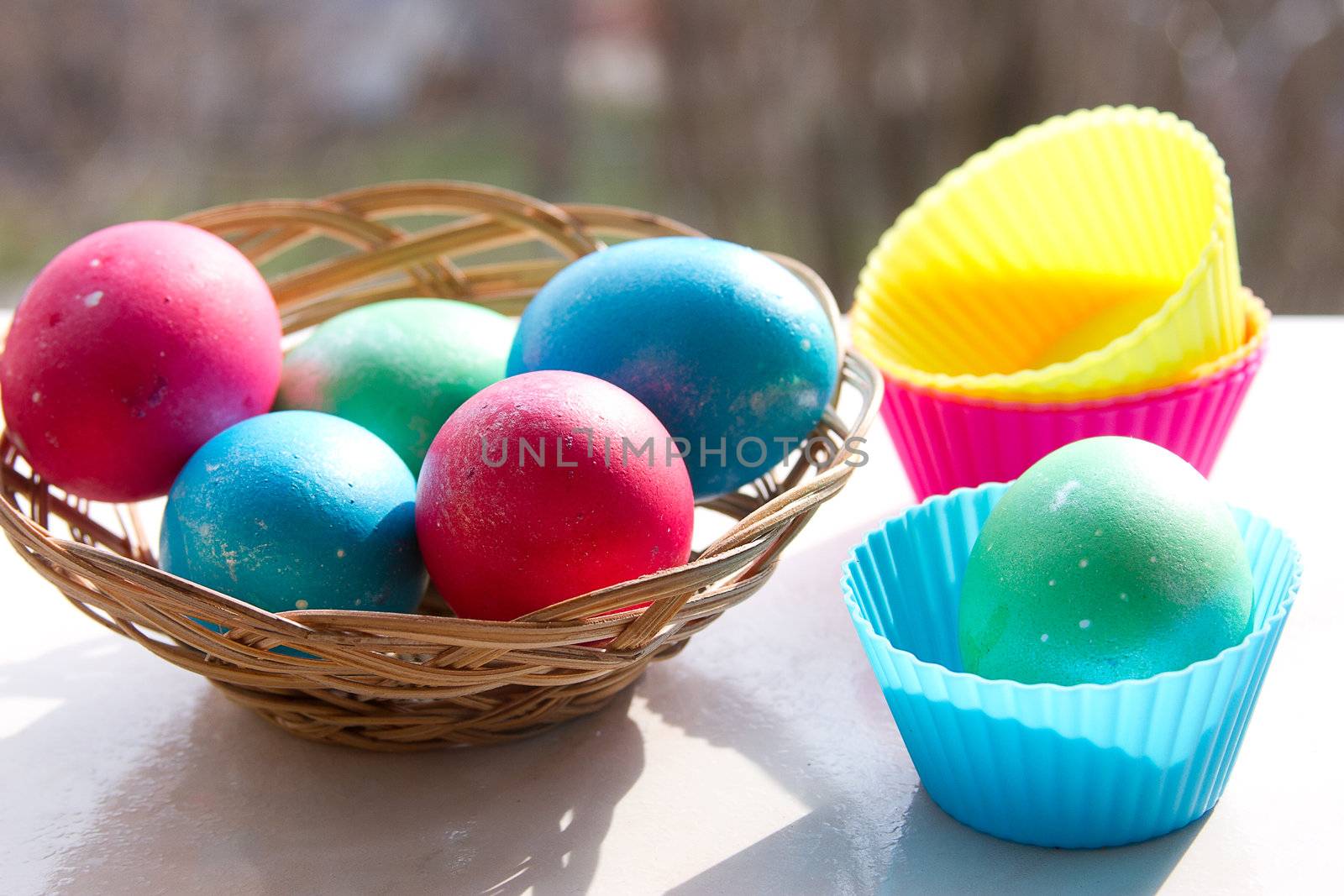 easter basket with easter eggs on wooden background