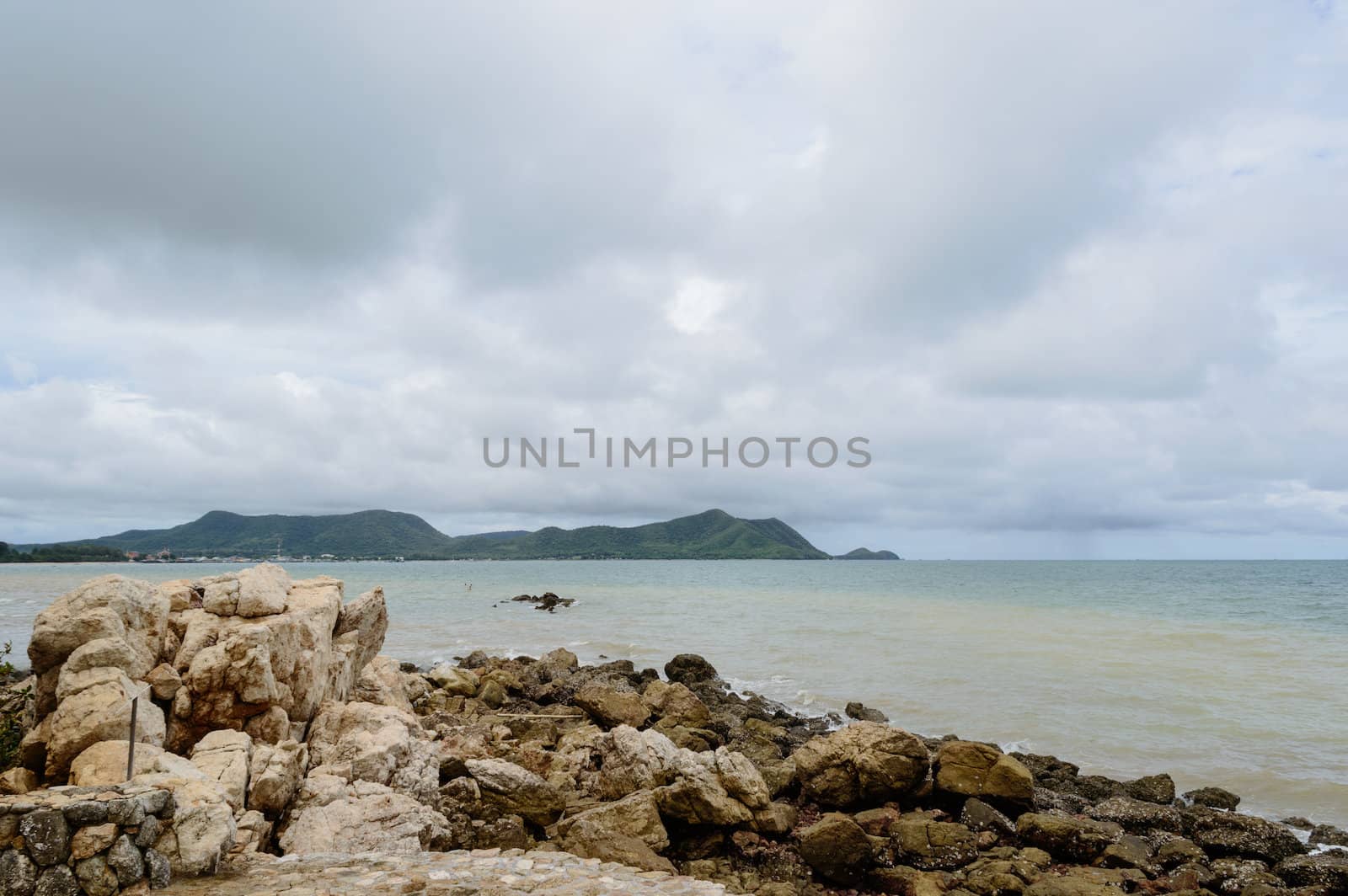 The rocks along the shoreline on the beach