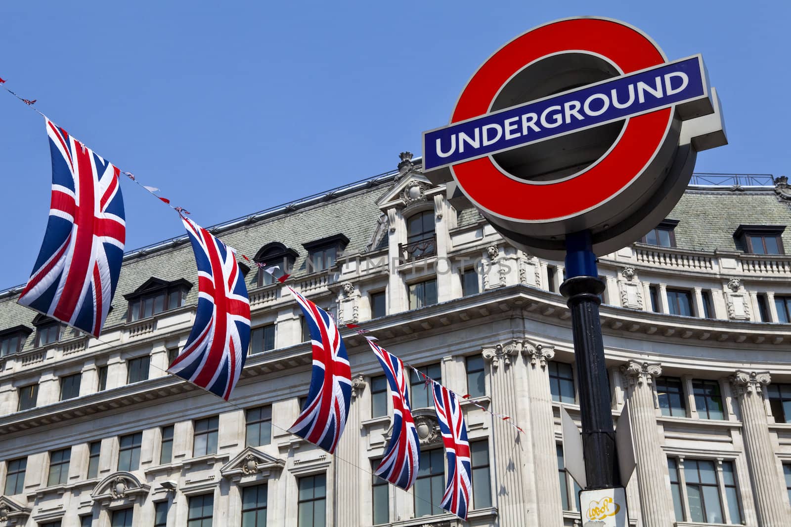 London Underground sign and Union Flags in London.