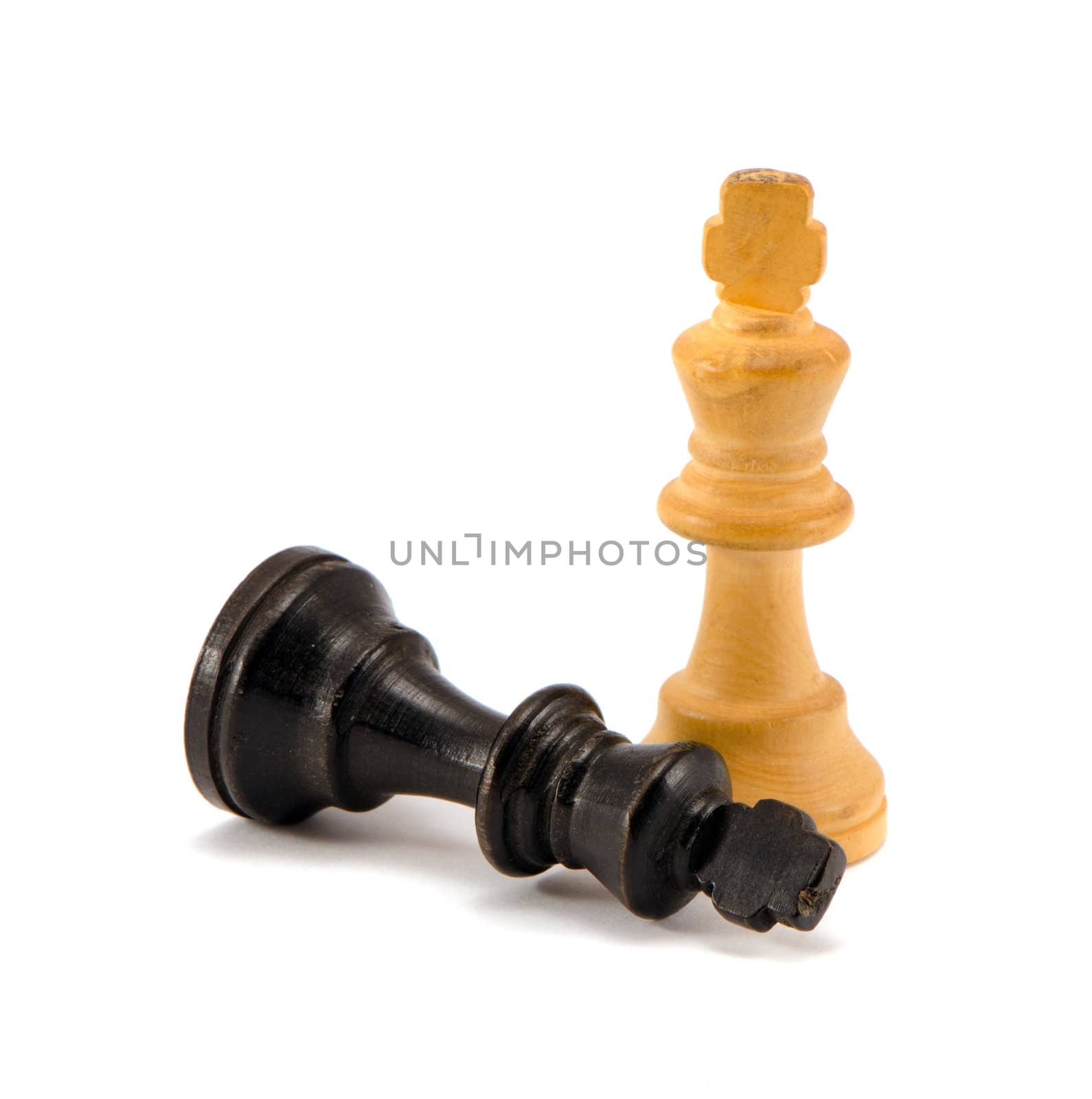 Black chess king lie near winner white legs by sauletas