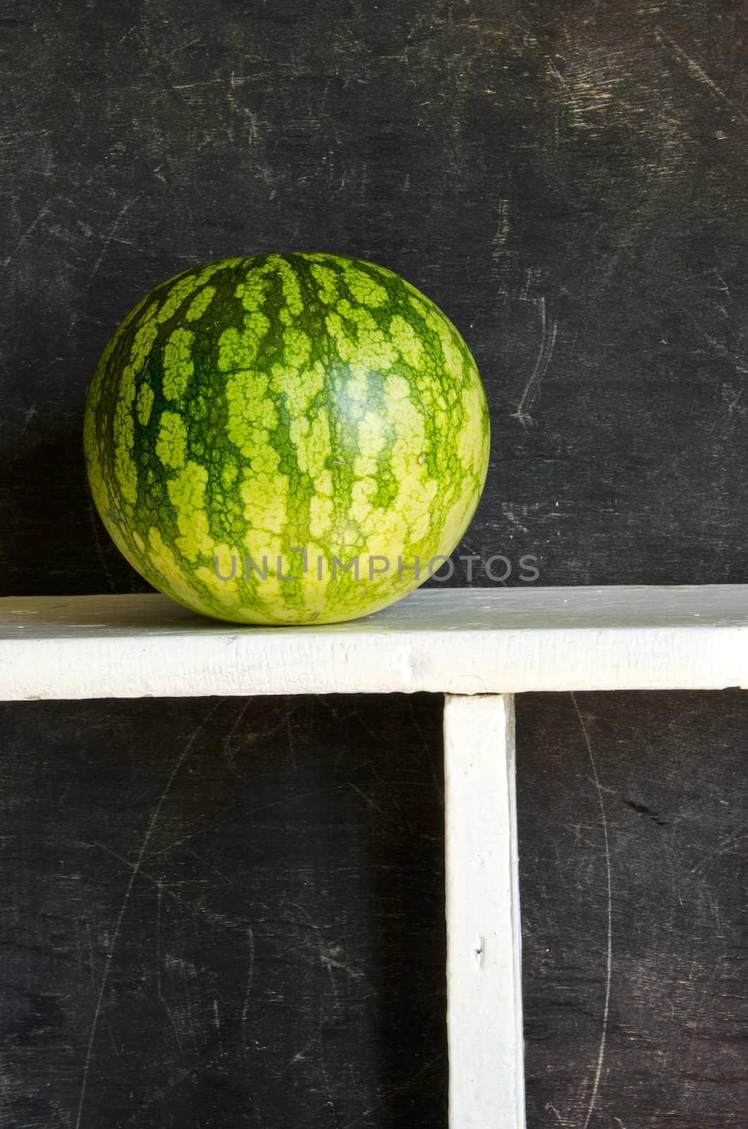 watermelon on wooden shelf by alis_photo