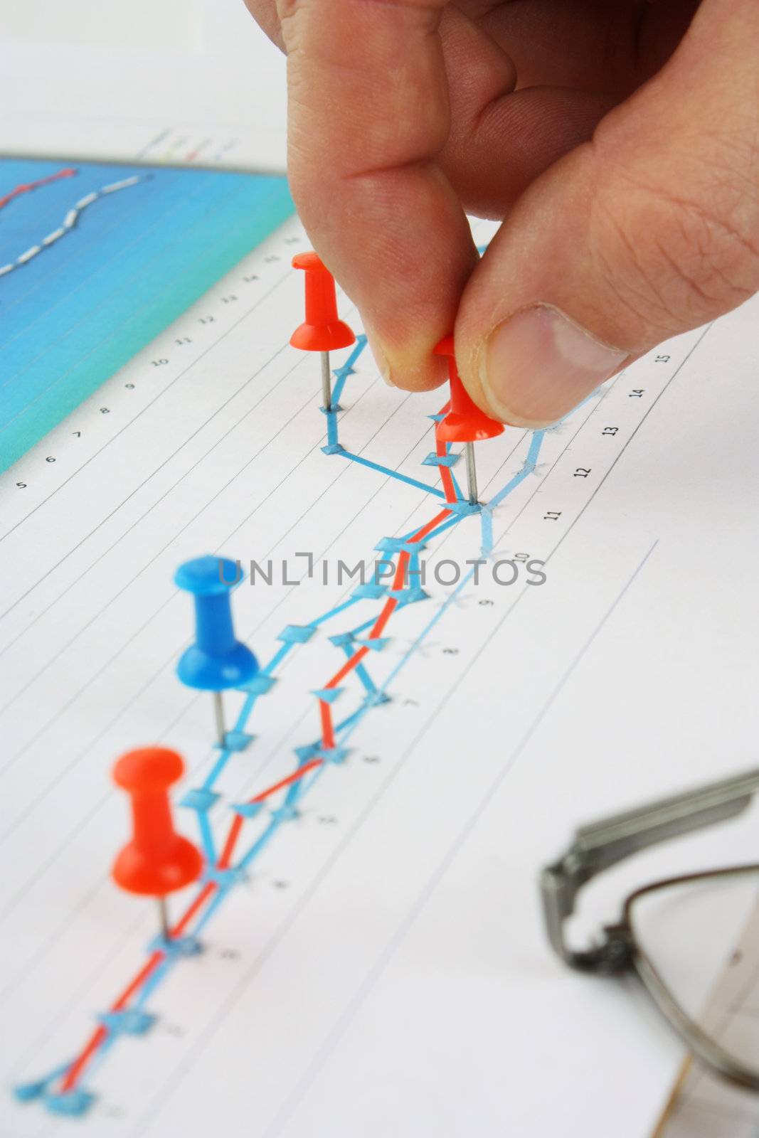 Graphs tables and documents laid on the table