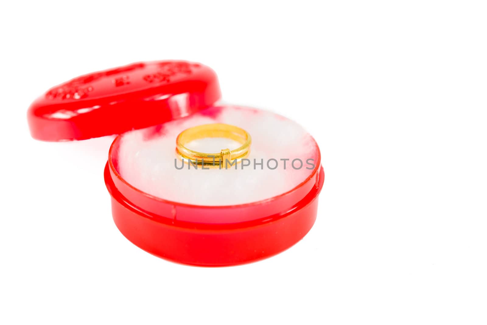Gold ring on red box on white background isolated