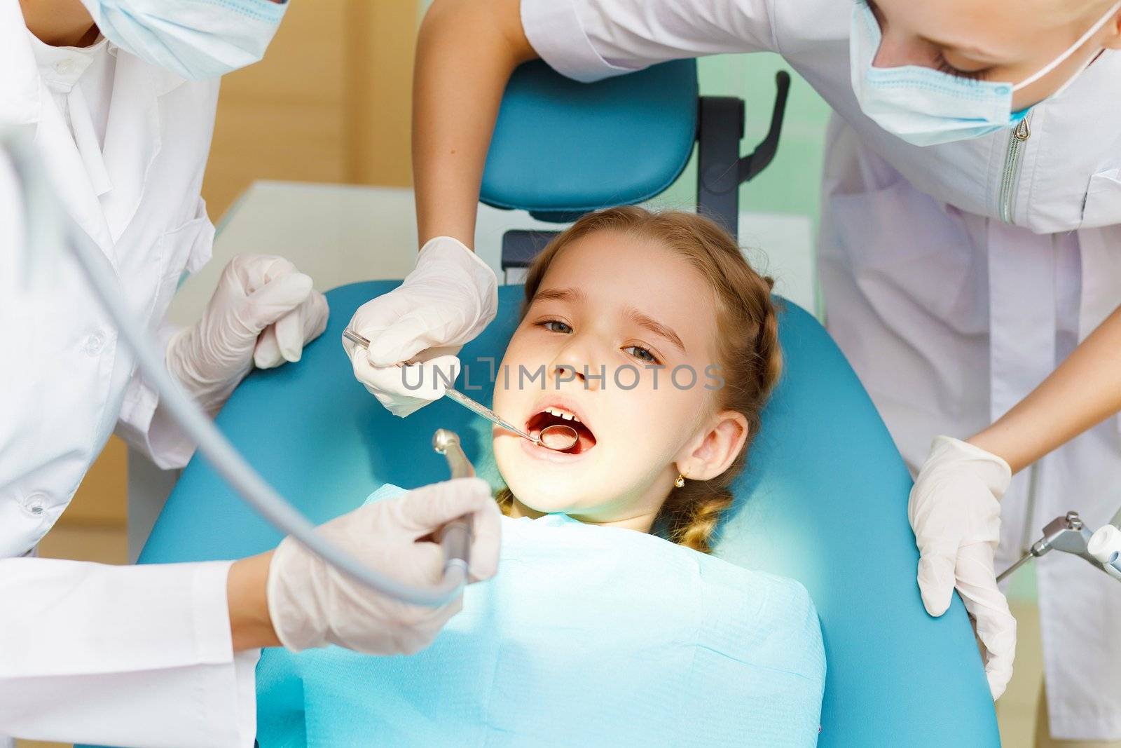 Little girl sitting in the dentists office