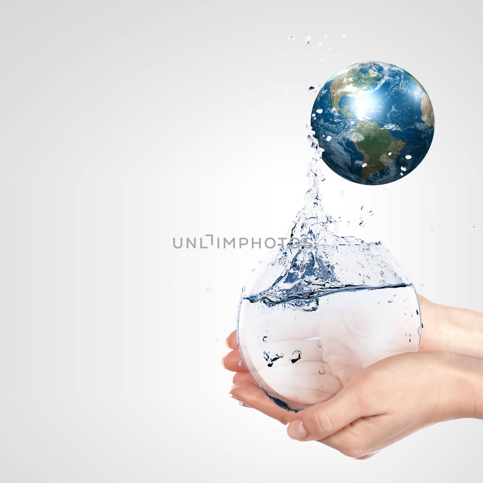 Globe in human hand against blue sky. Environmental protection concept. Elements of this image furnished by NASA