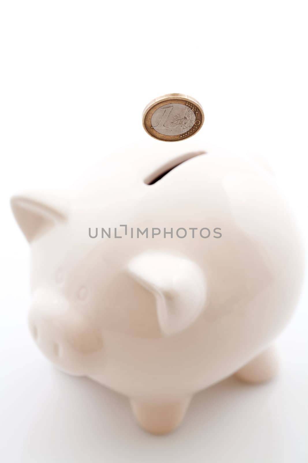 Piggy bank money box. Money (euro) is falling through piggy bank