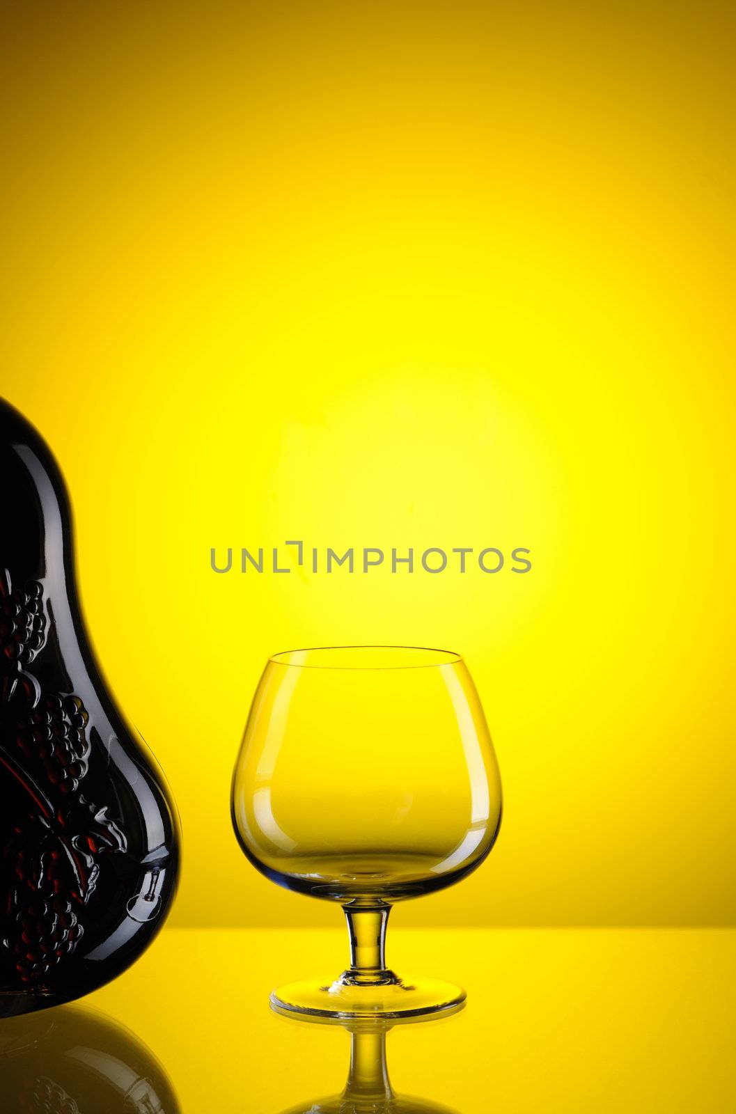 Cognac bottle and glass still life