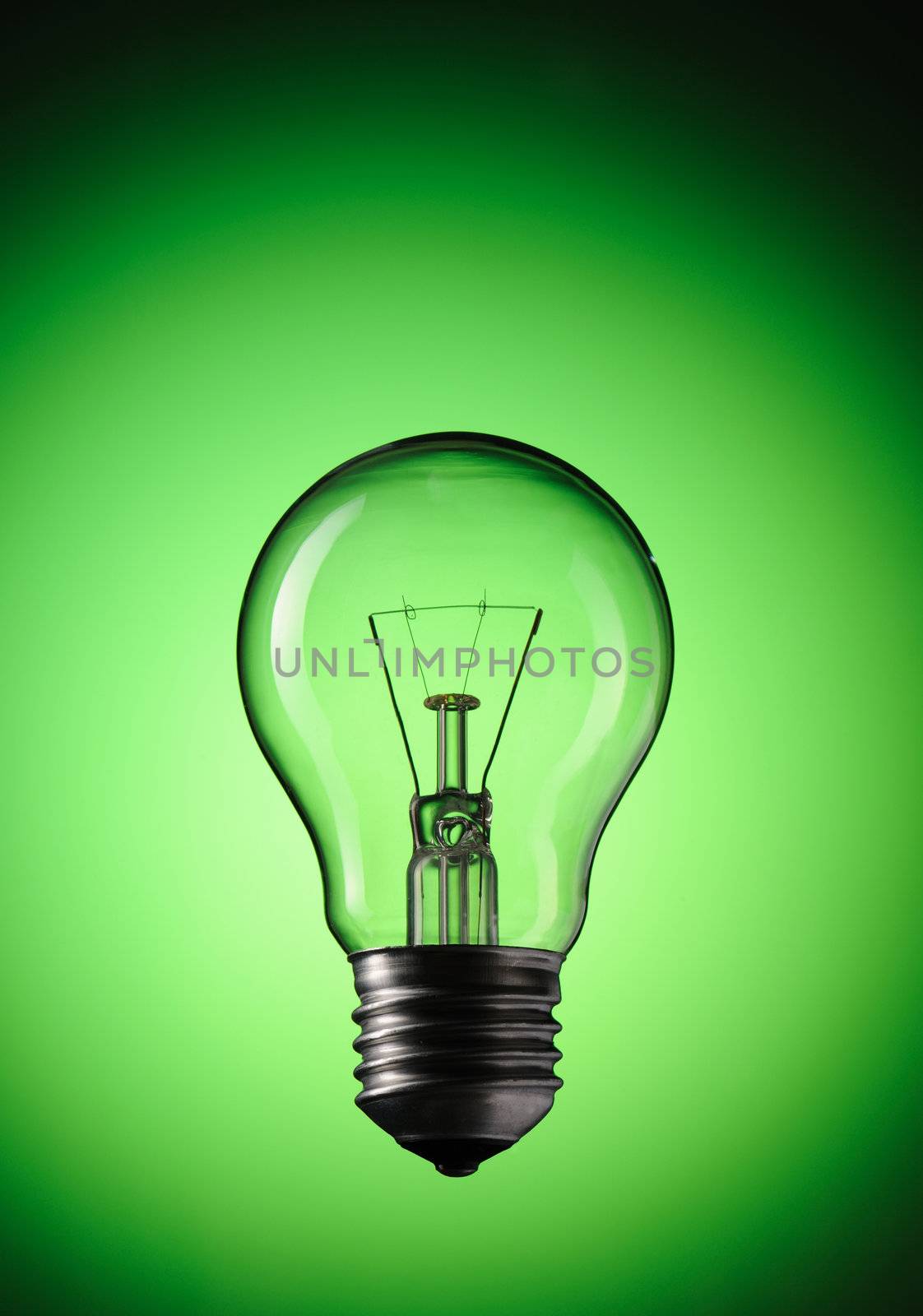 Light Bulb over green background