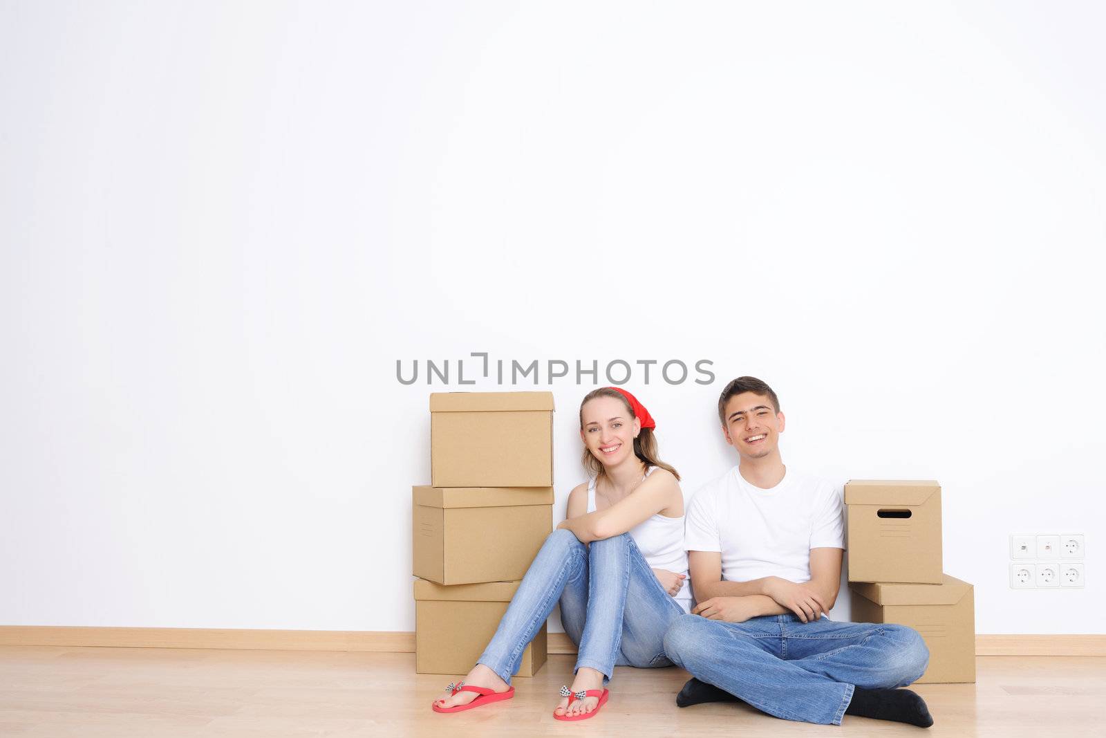 Young couple resting from moving into a new home