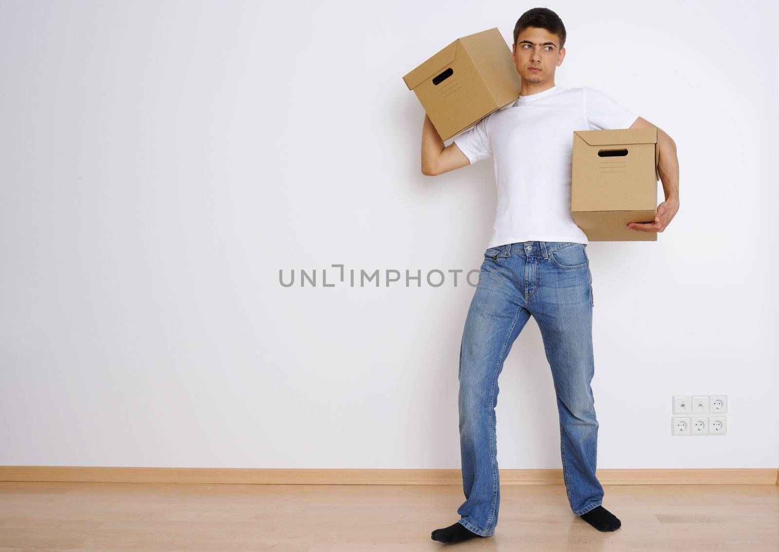 Young man carrying two boxes