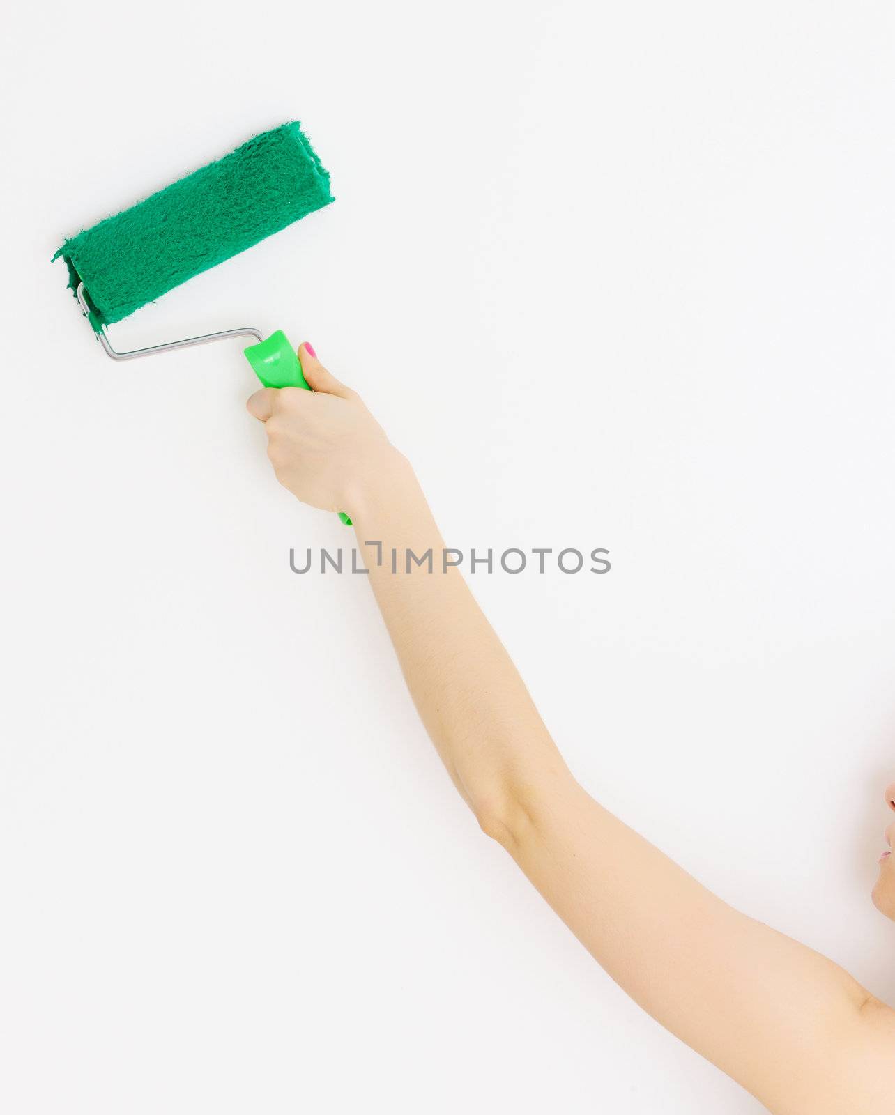 Painting interior wall of home with paint roller