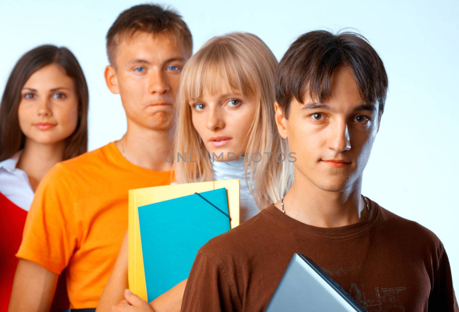  Casual group of college students smiling stand in a row with books on white 