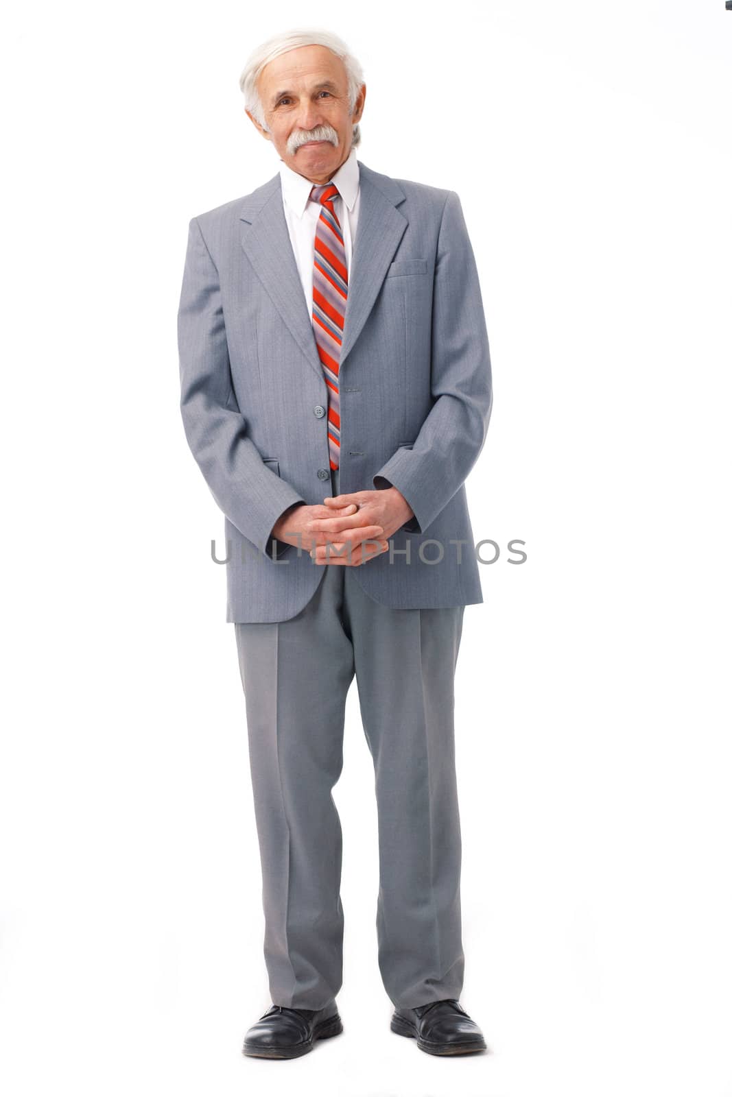 Full length portrait of an elder man standing over white.