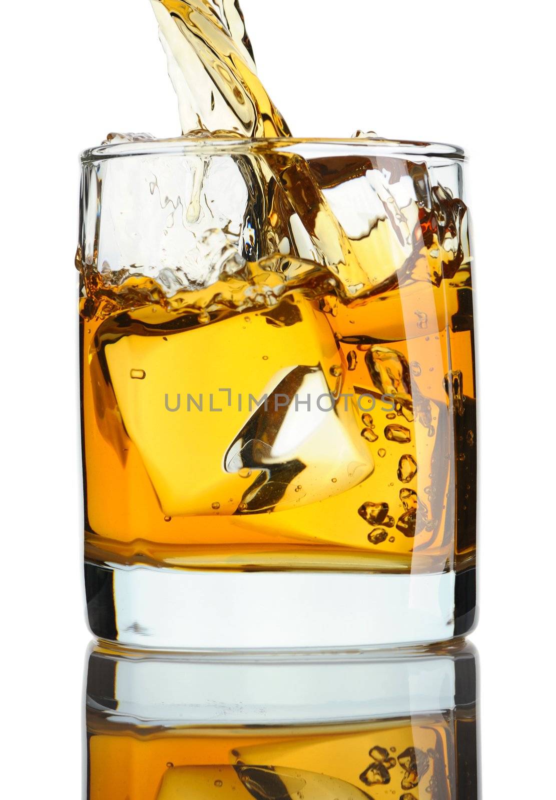 Pouring whiskey in glass with ice isolated on white