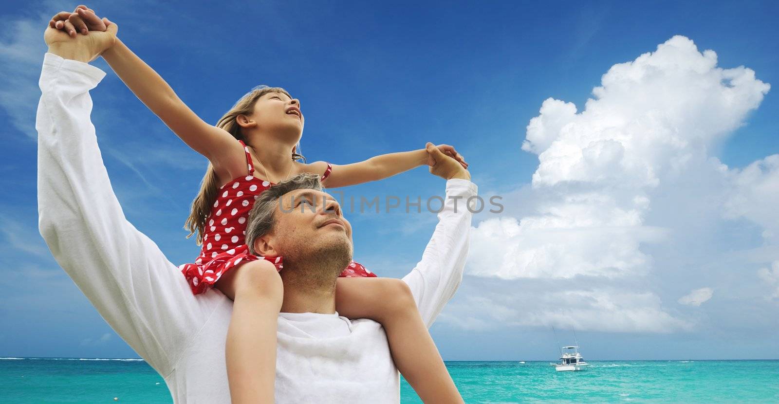 Father and daughter against sky 