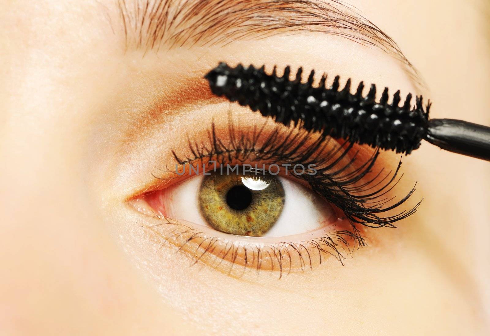 Woman eye with long eyelashes and mascara brush