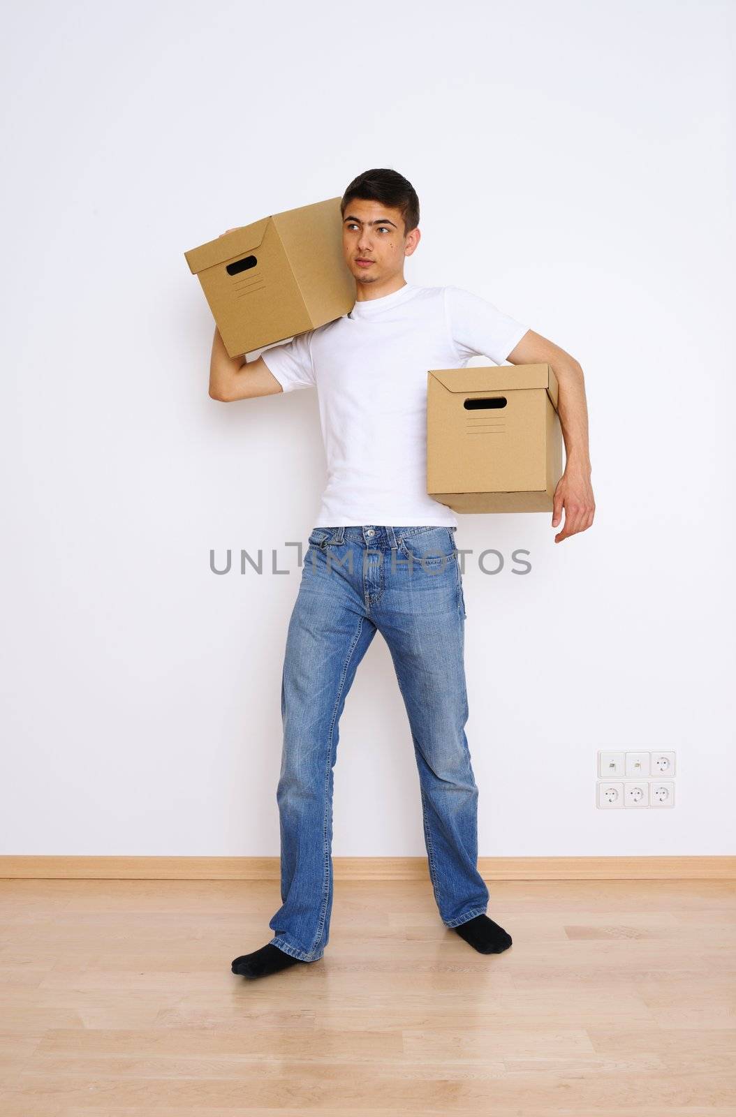 Young man carrying two boxes