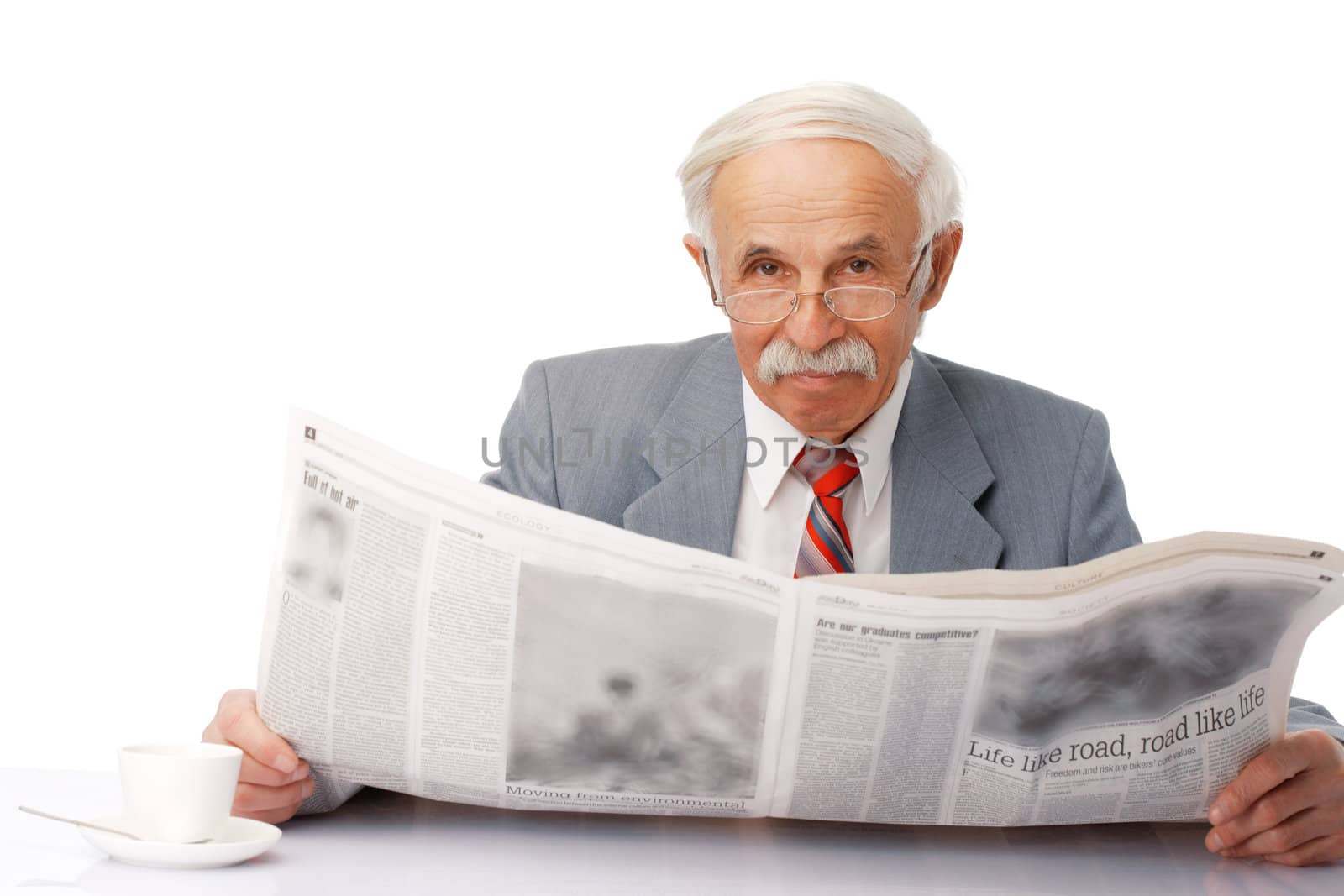 Portrait of an elder happy man reading a newspaper