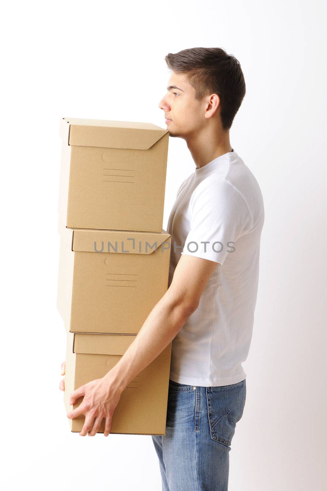 Young man carrying a stack of boxes