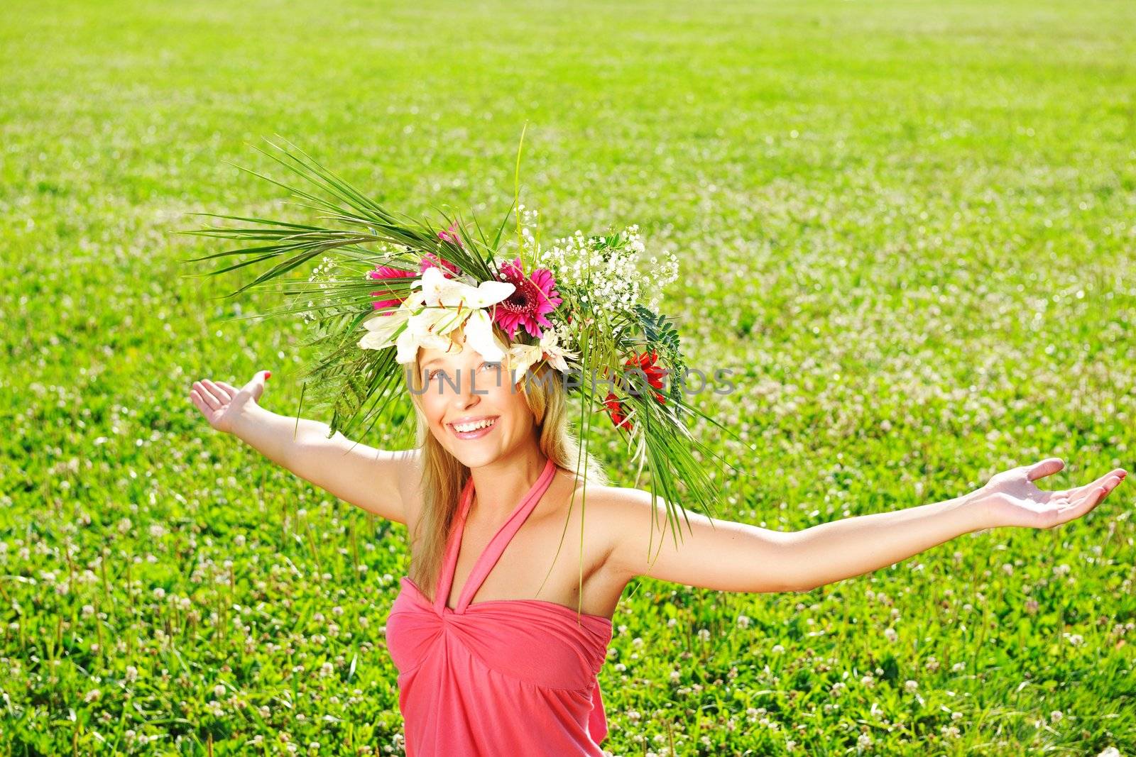 Girl wearing a wreath made from flowers with outstretched arms