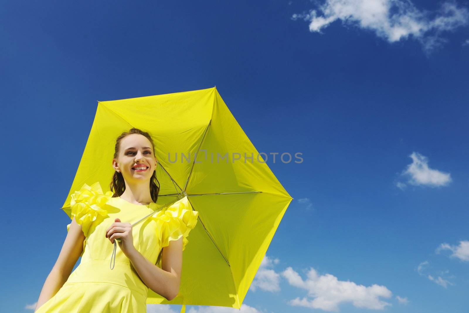 Woman holding umbrella against sky