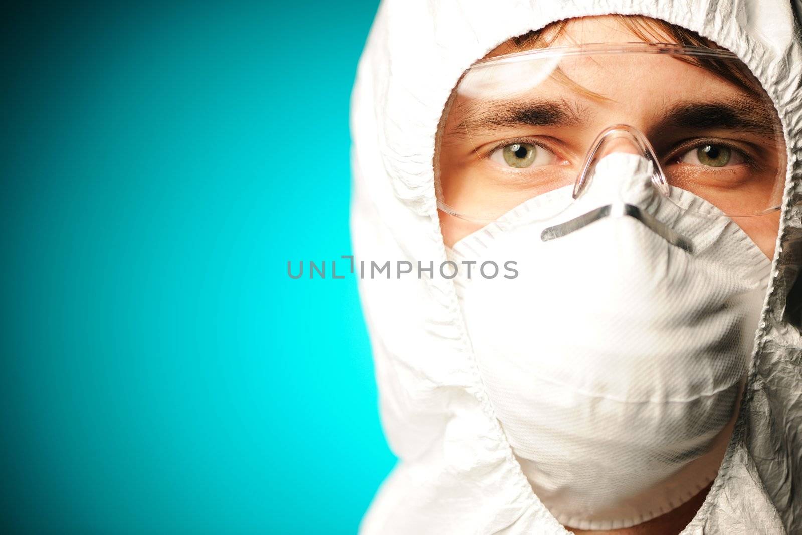 Scientist in protective wear, glasses and respirator 