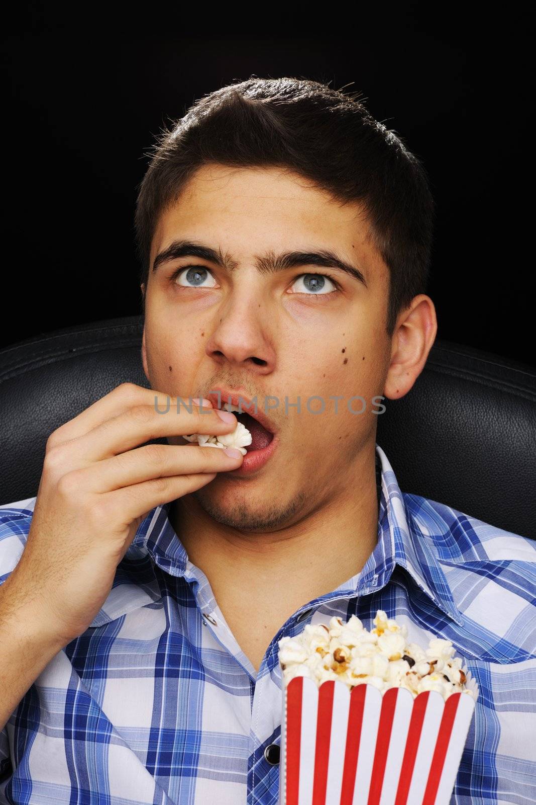 Young man watching movie at cinema