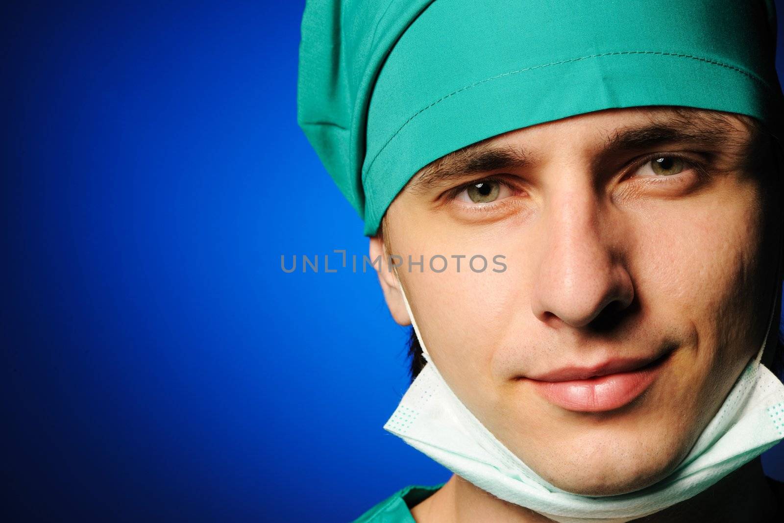 Surgeon with mask over blue