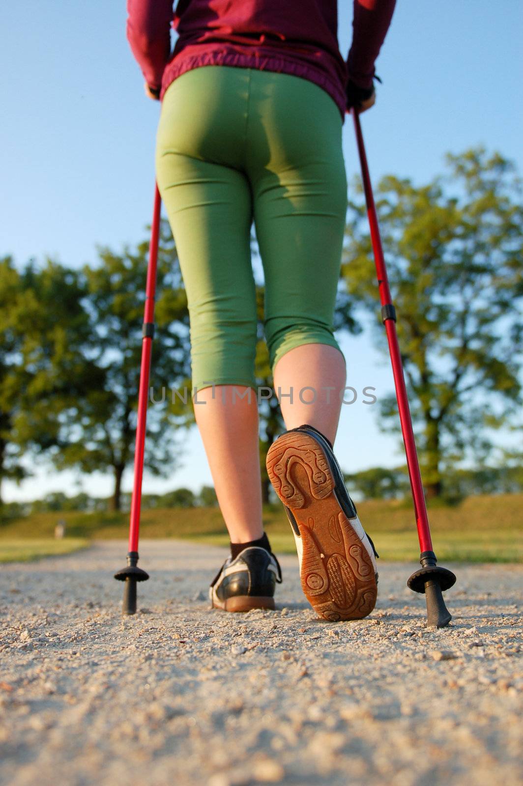 Closeup of woman's legs with nordic walking poles