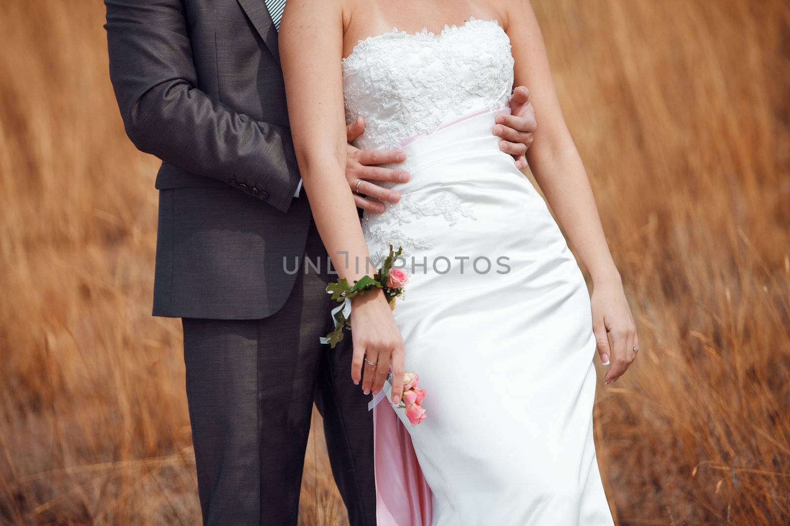 bride and groom in the field 