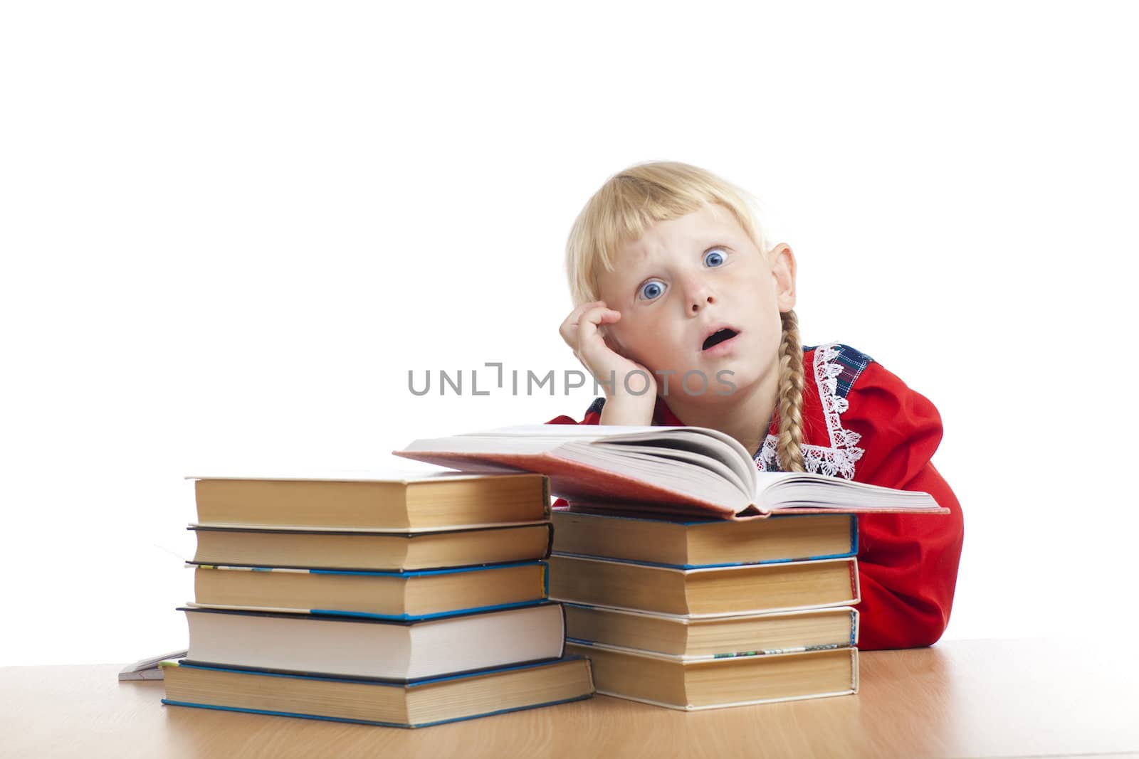 tired small girl with many books