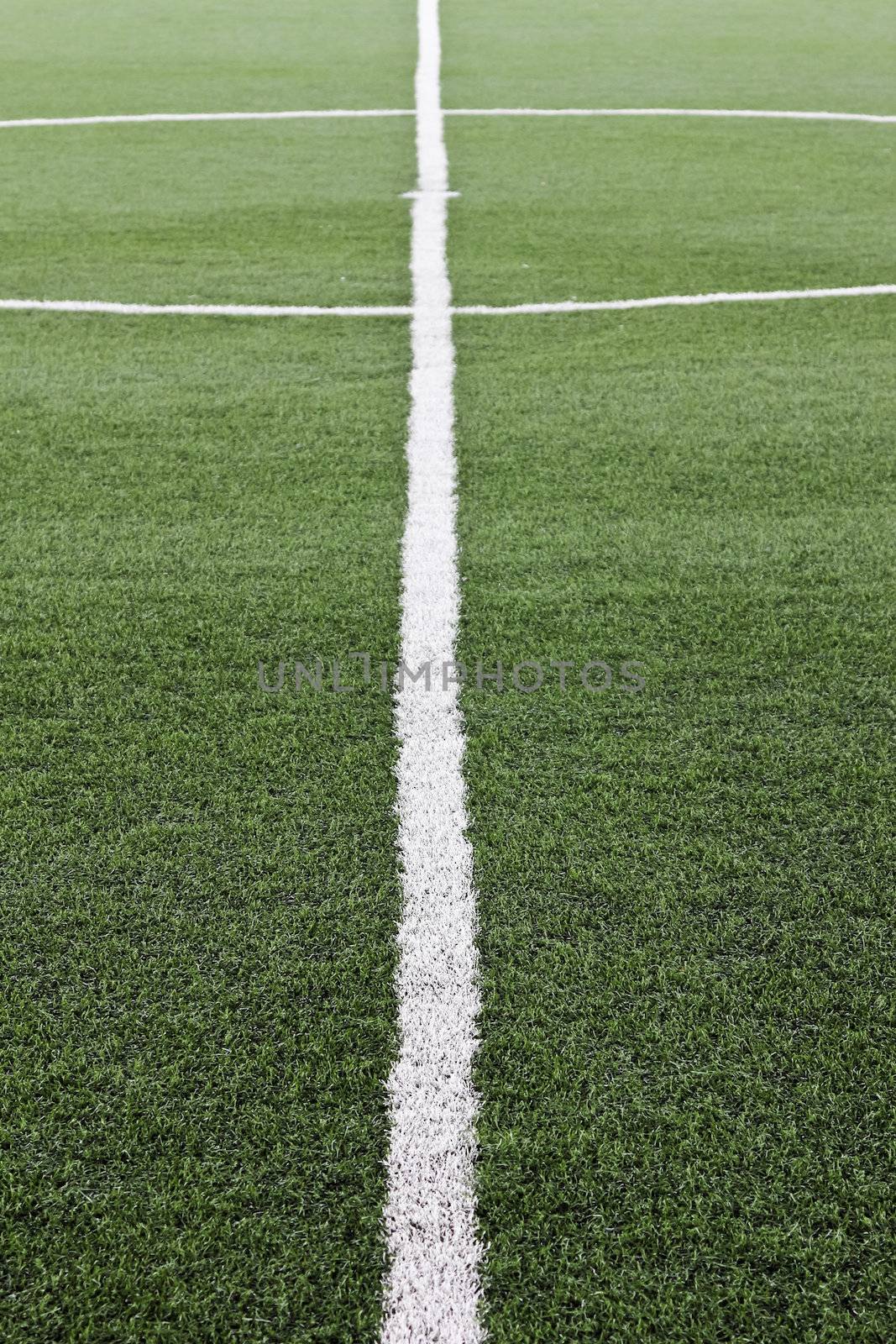 Green artificial grass soccer field for background