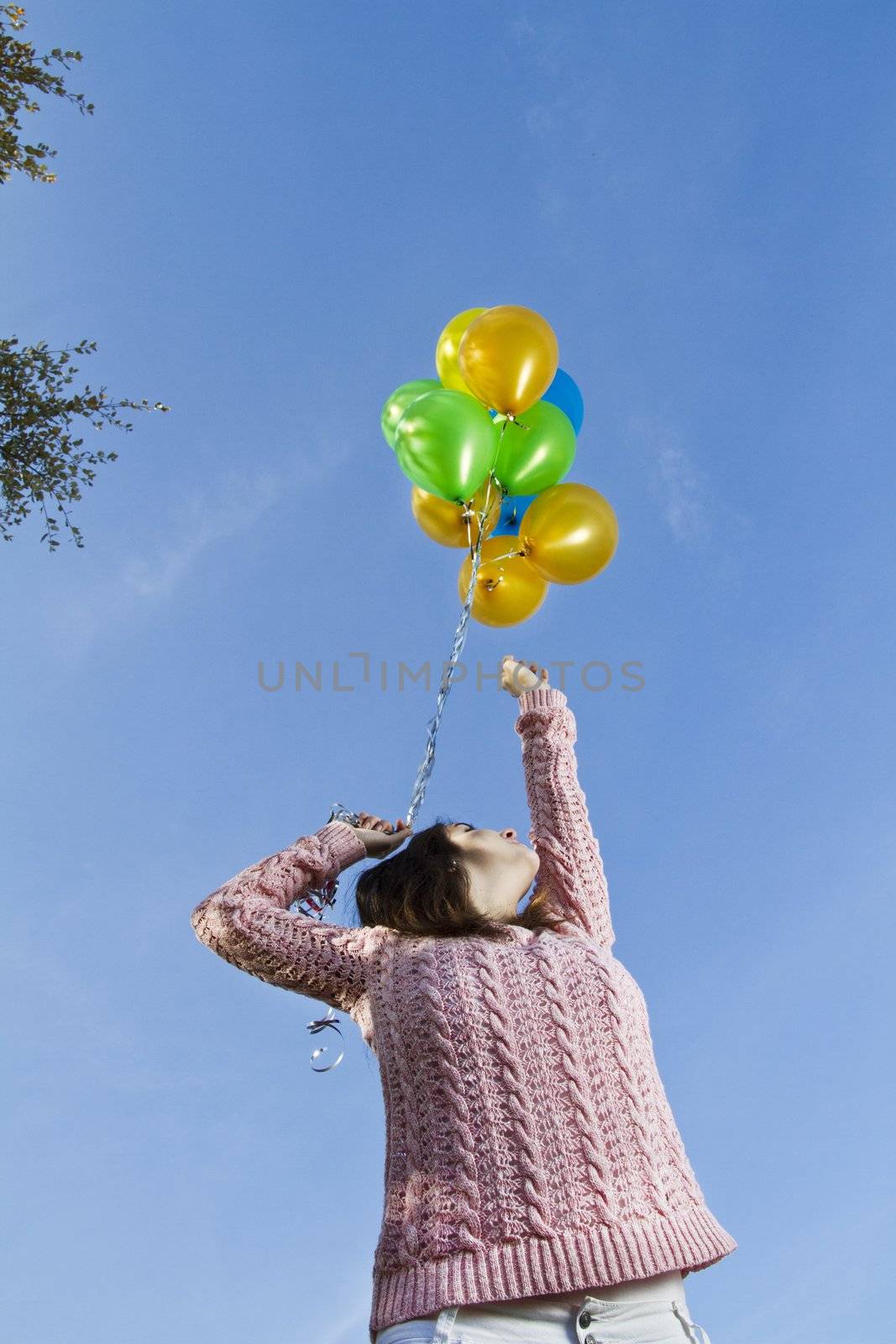 View of a beautiful girl with balloons on nature.