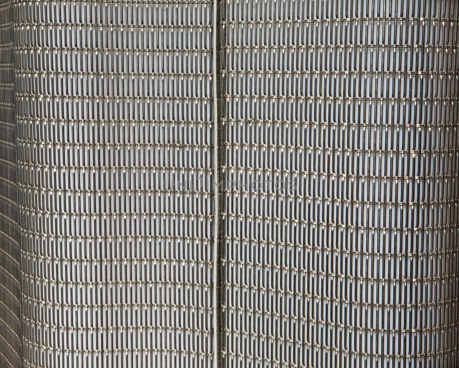 Abstract metal grid wall that is part of a city light rail stop