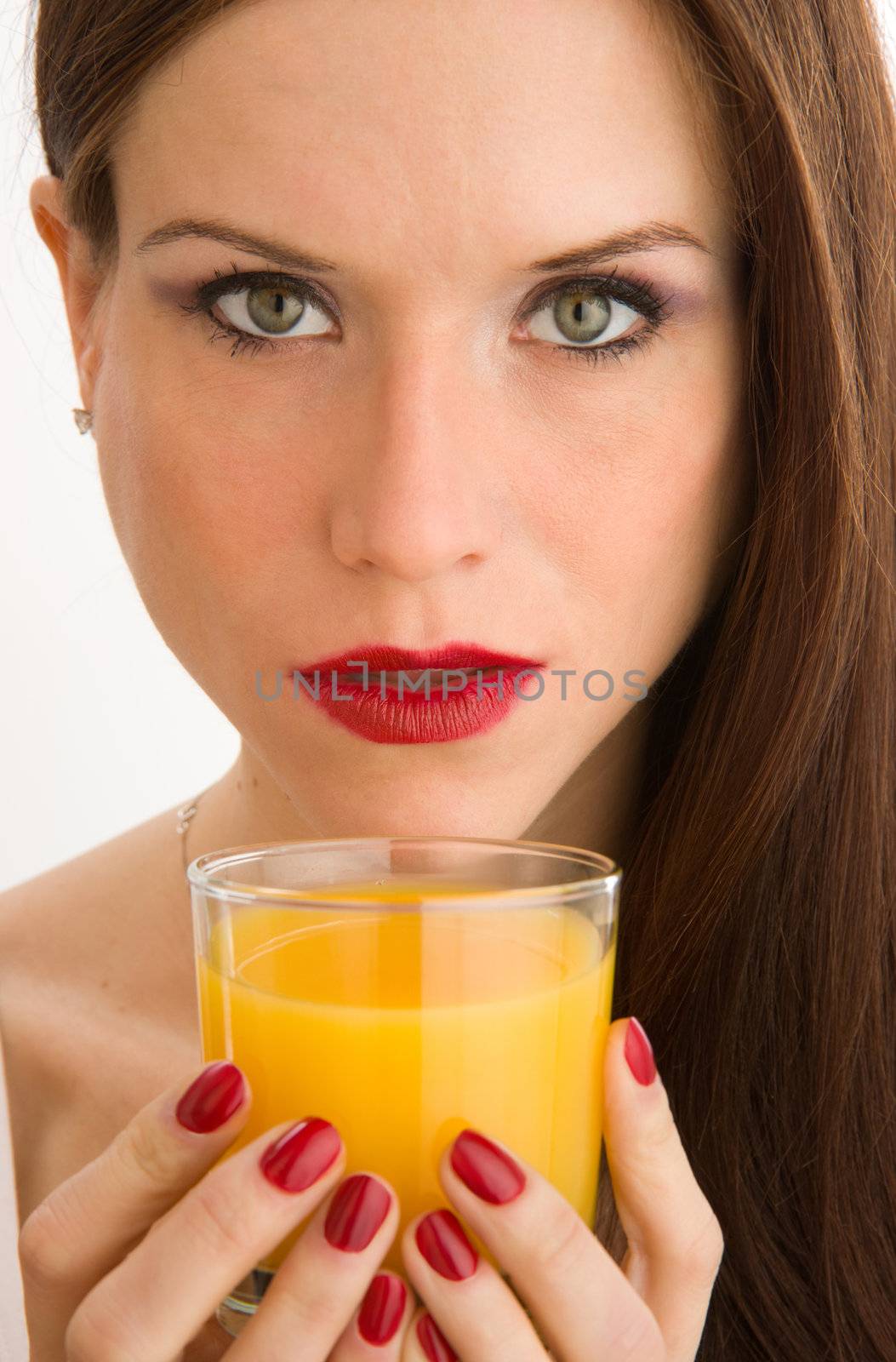 Colorful Woman's hand holds a glass of Orange Juice