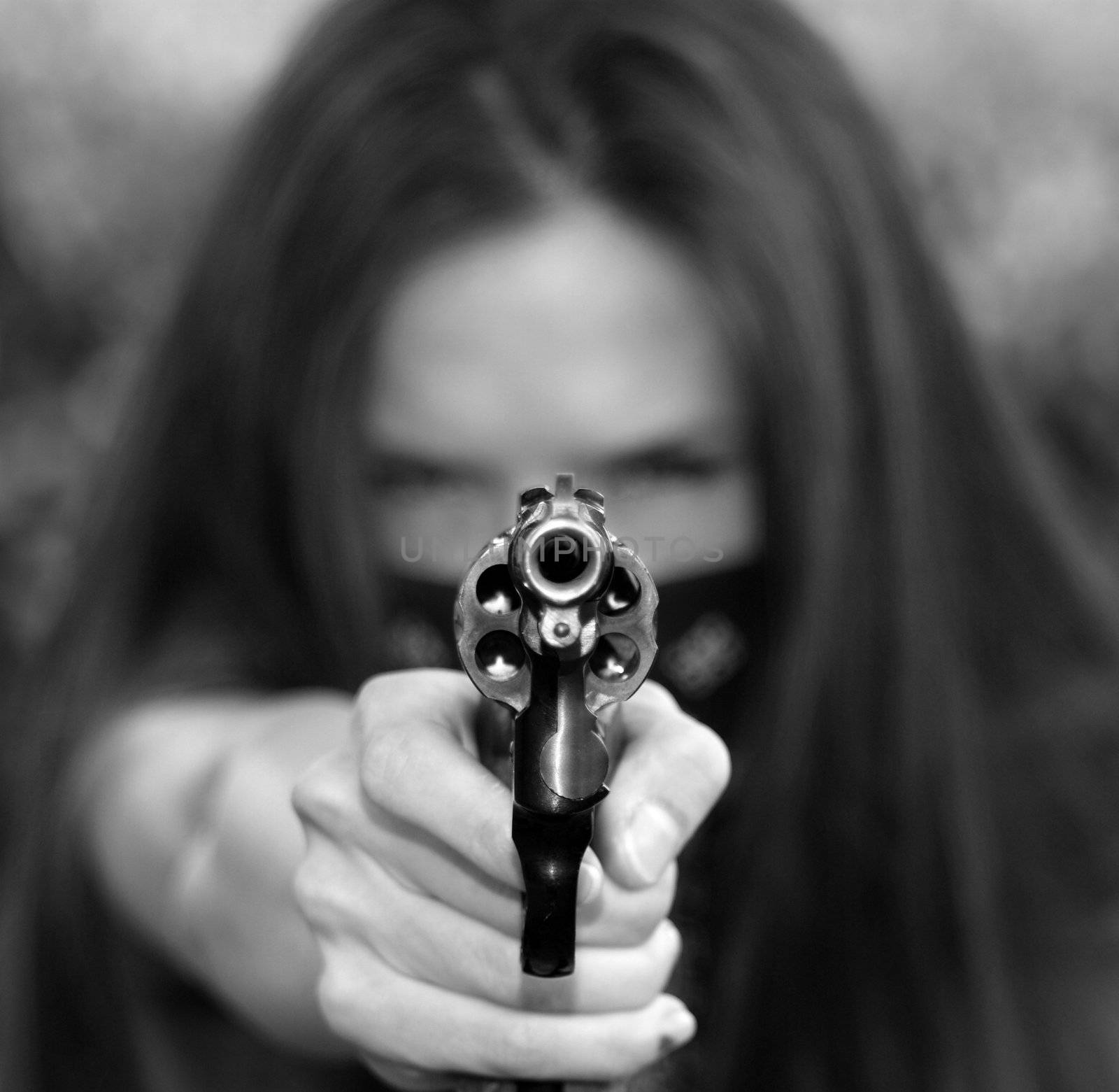 Girl with a revolver pointed at the viewer