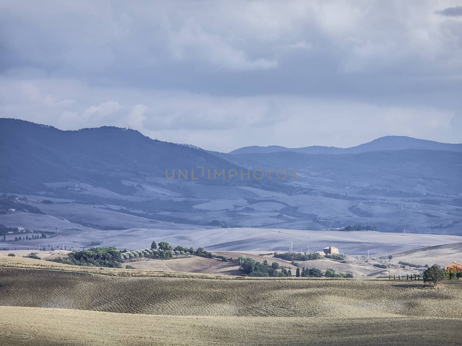 tuscan mountain range and field